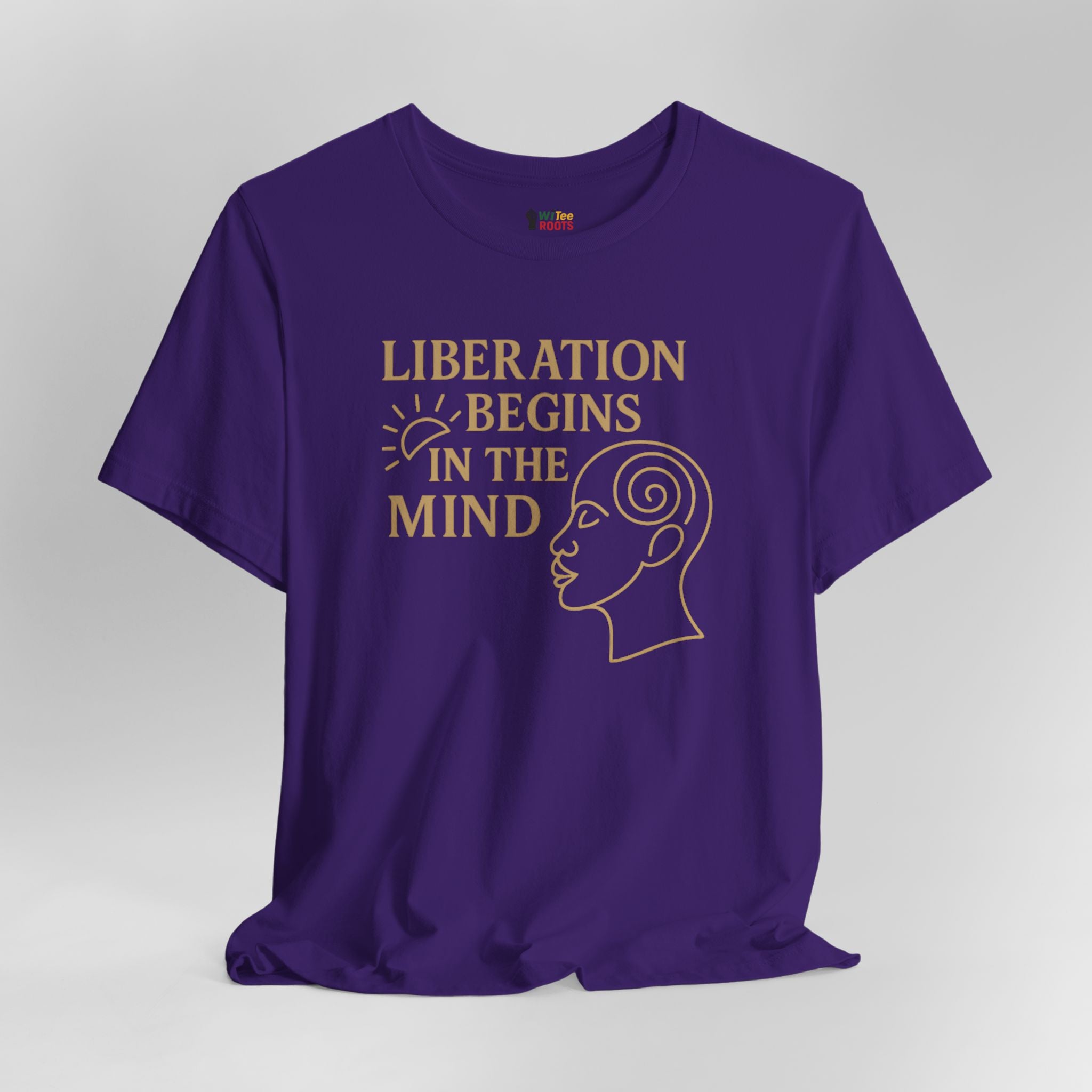 Purple t-shirt with 'Liberation Begins in the Mind' text and graphic on a gray background