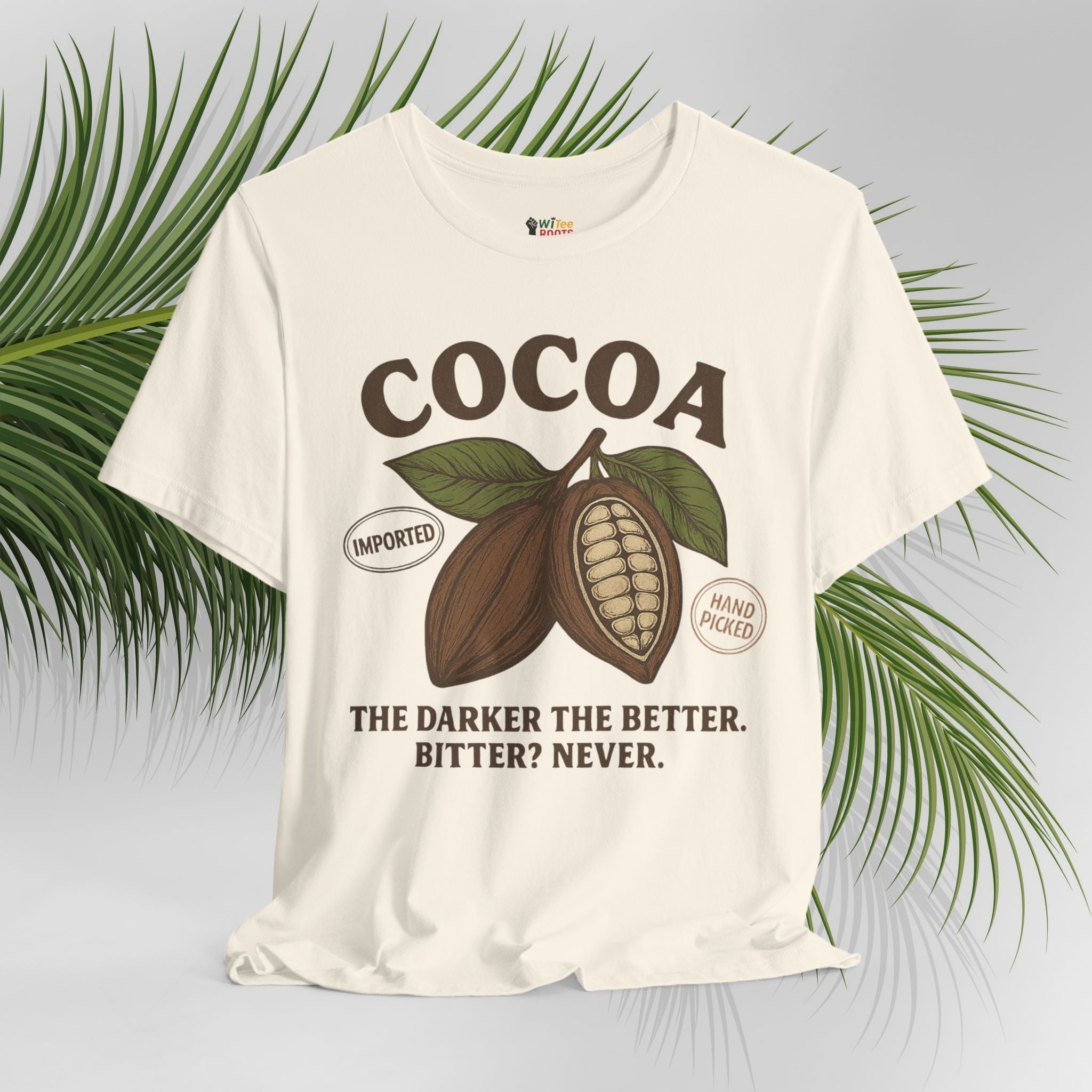Beige t-shirt with cocoa graphic and text on a light gray background with green leaves.