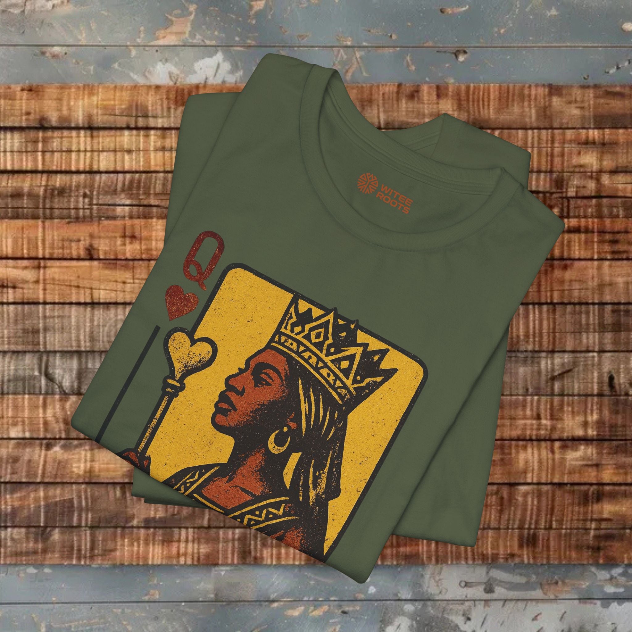 Green t-shirt with a graphic design of a woman on a wooden surface