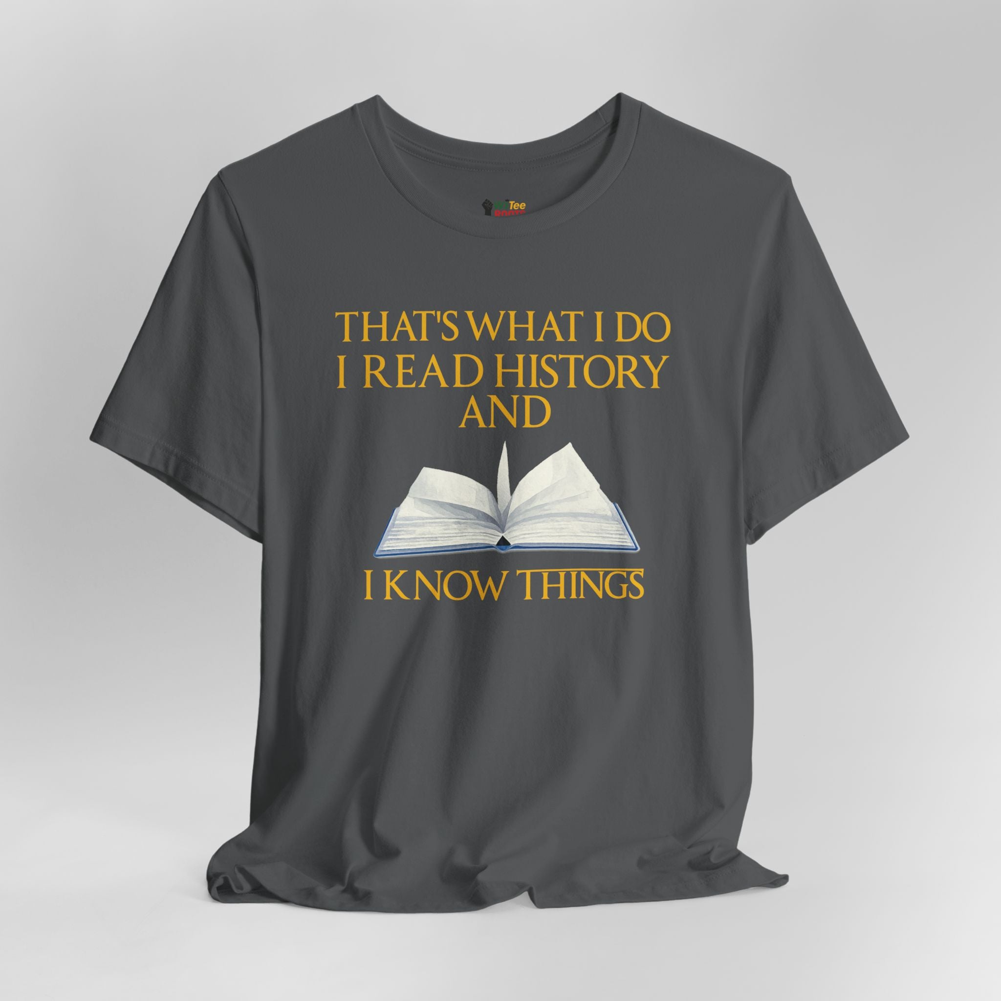 Gray t-shirt with yellow text and an open book graphic on a gray background