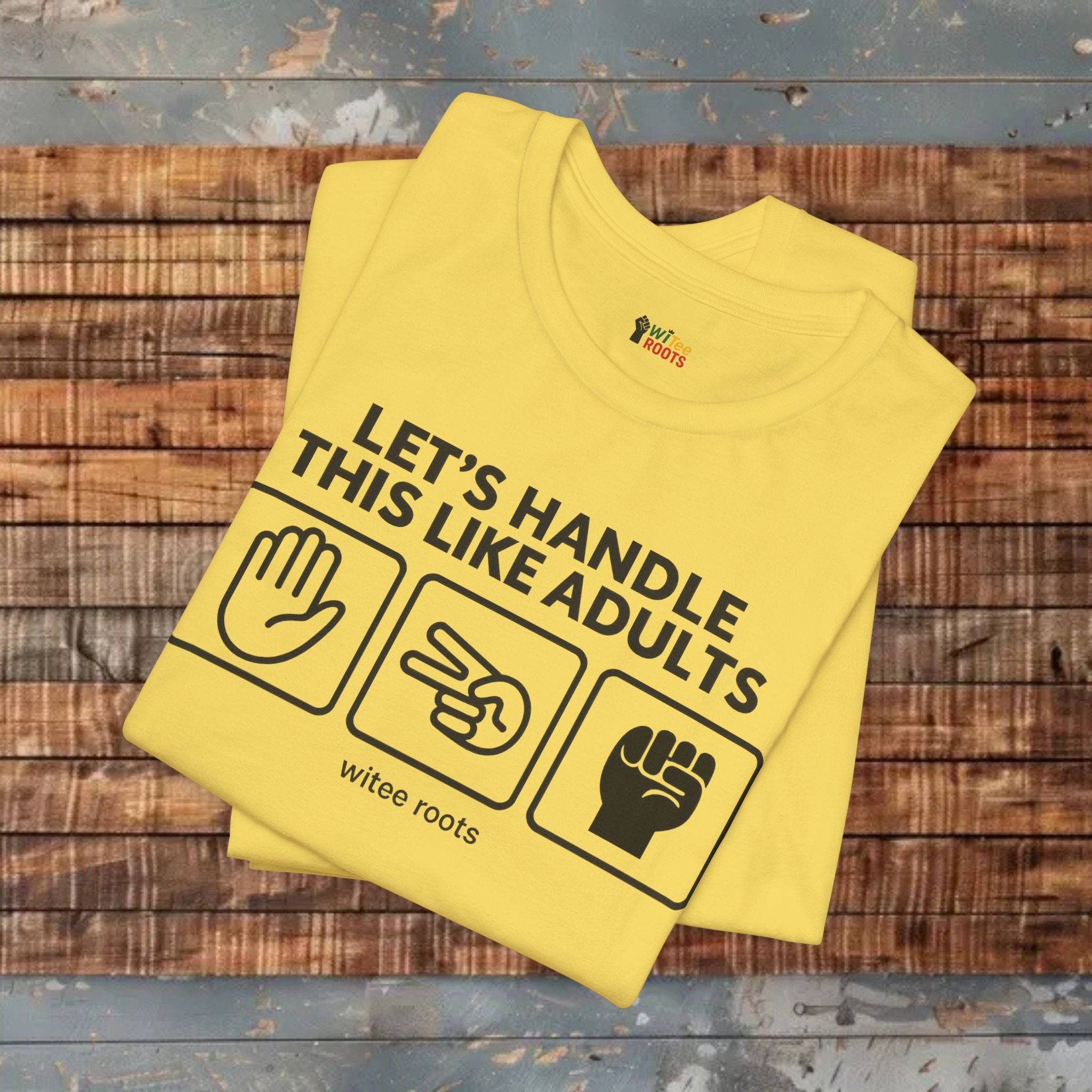 Yellow t-shirt with text and icons on a wooden surface