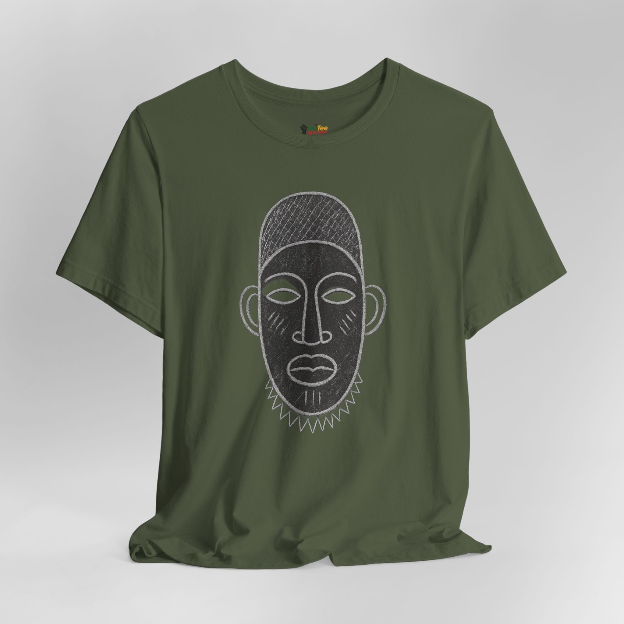 Green t-shirt with a face design on a gray background