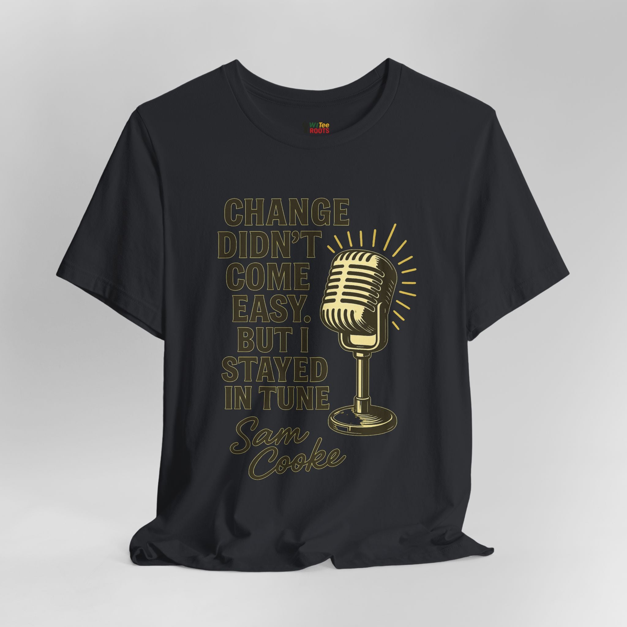 Black t-shirt with gold microphone graphic and text on a gray background