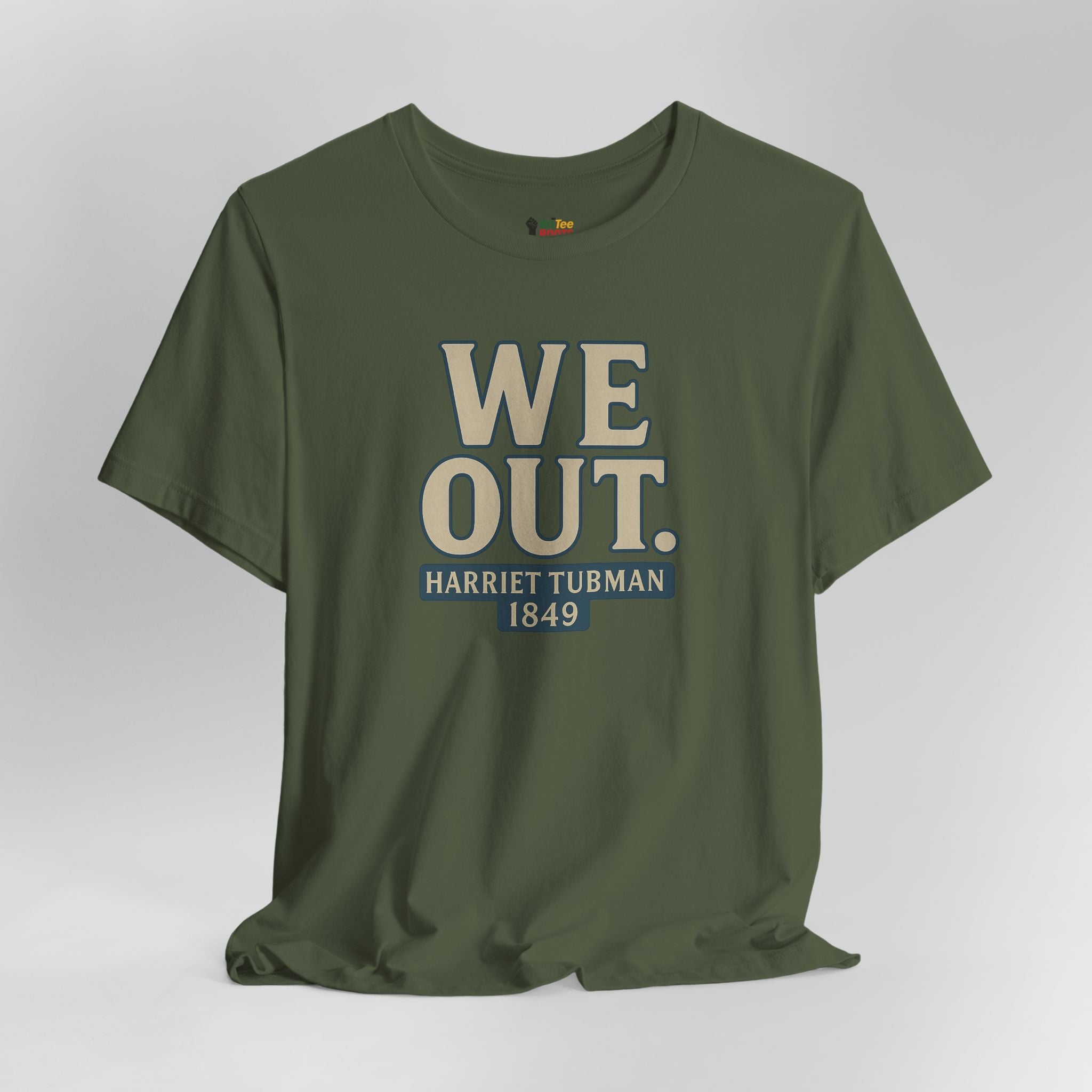 Green t-shirt with 'WE OUT. HARRIET TUBMAN 1849' text on a gray background