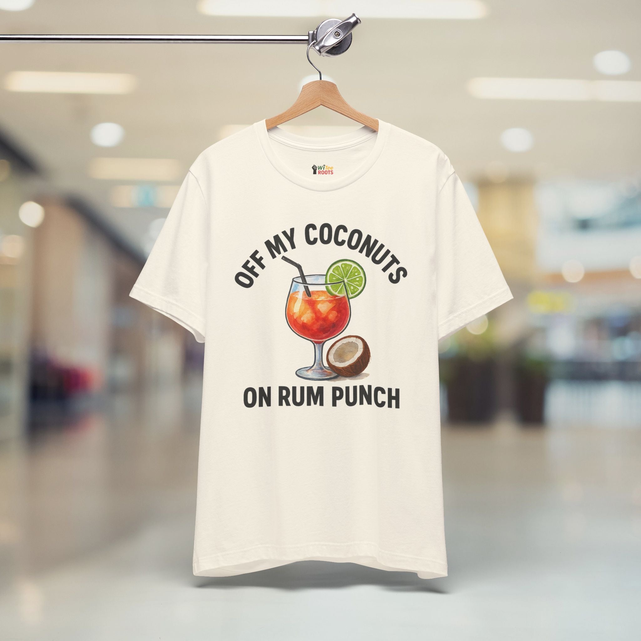 Beige t-shirt with a graphic design and text on a hanger in a store setting