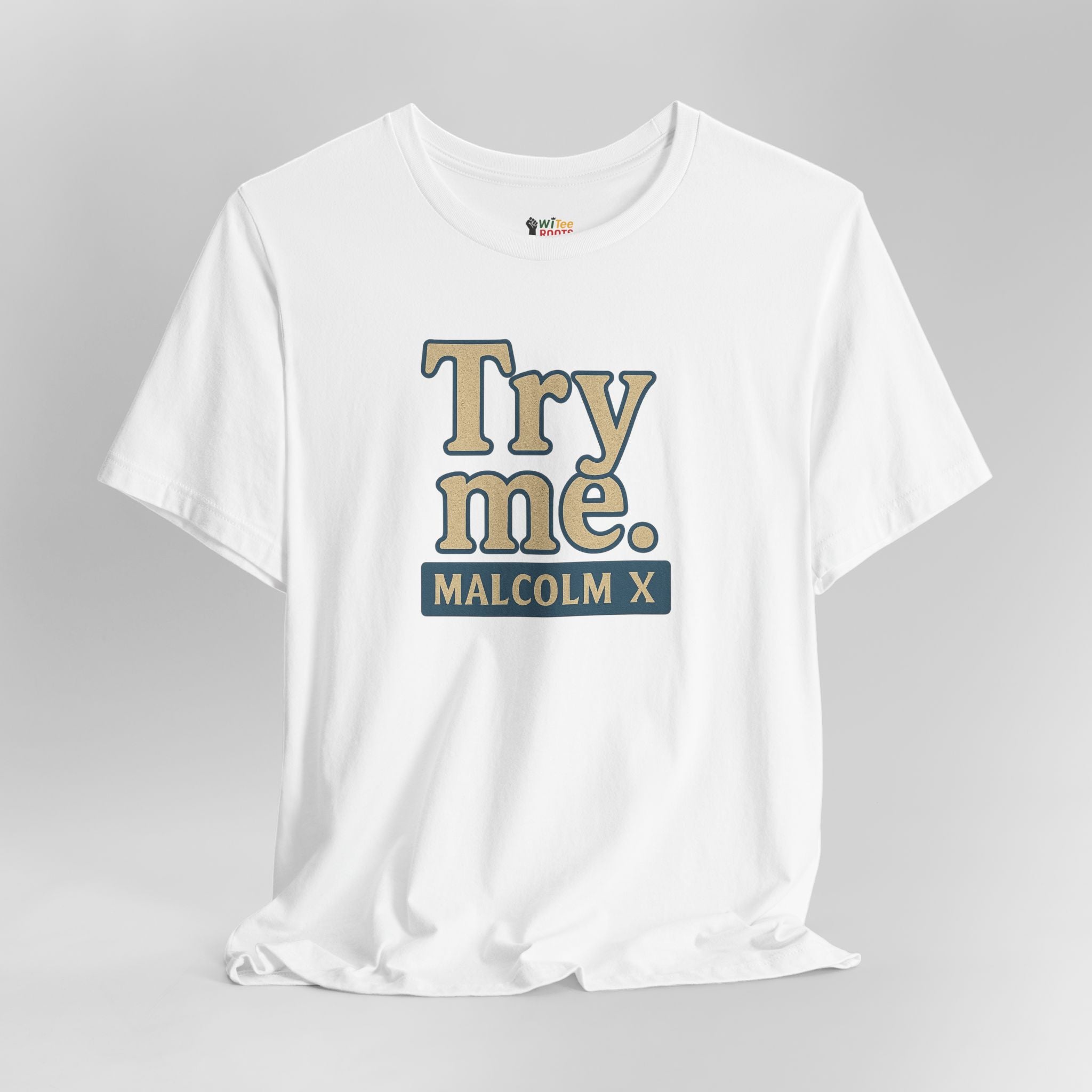 White t-shirt with 'Try me. Malcolm X' text on a gray background