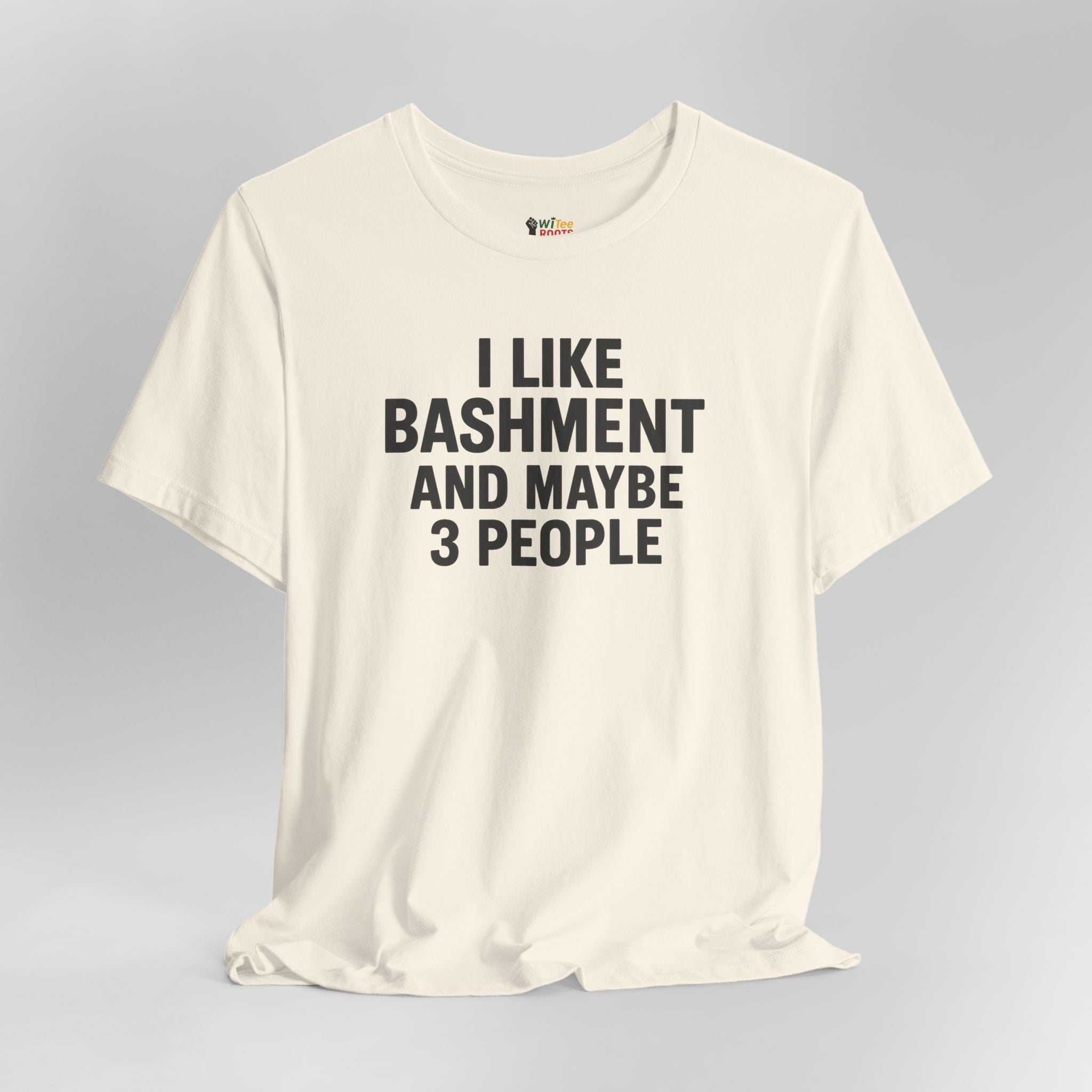 Cream t-shirt with text 'I LIKE BASHMENT AND MAYBE 3 PEOPLE' on a gray background