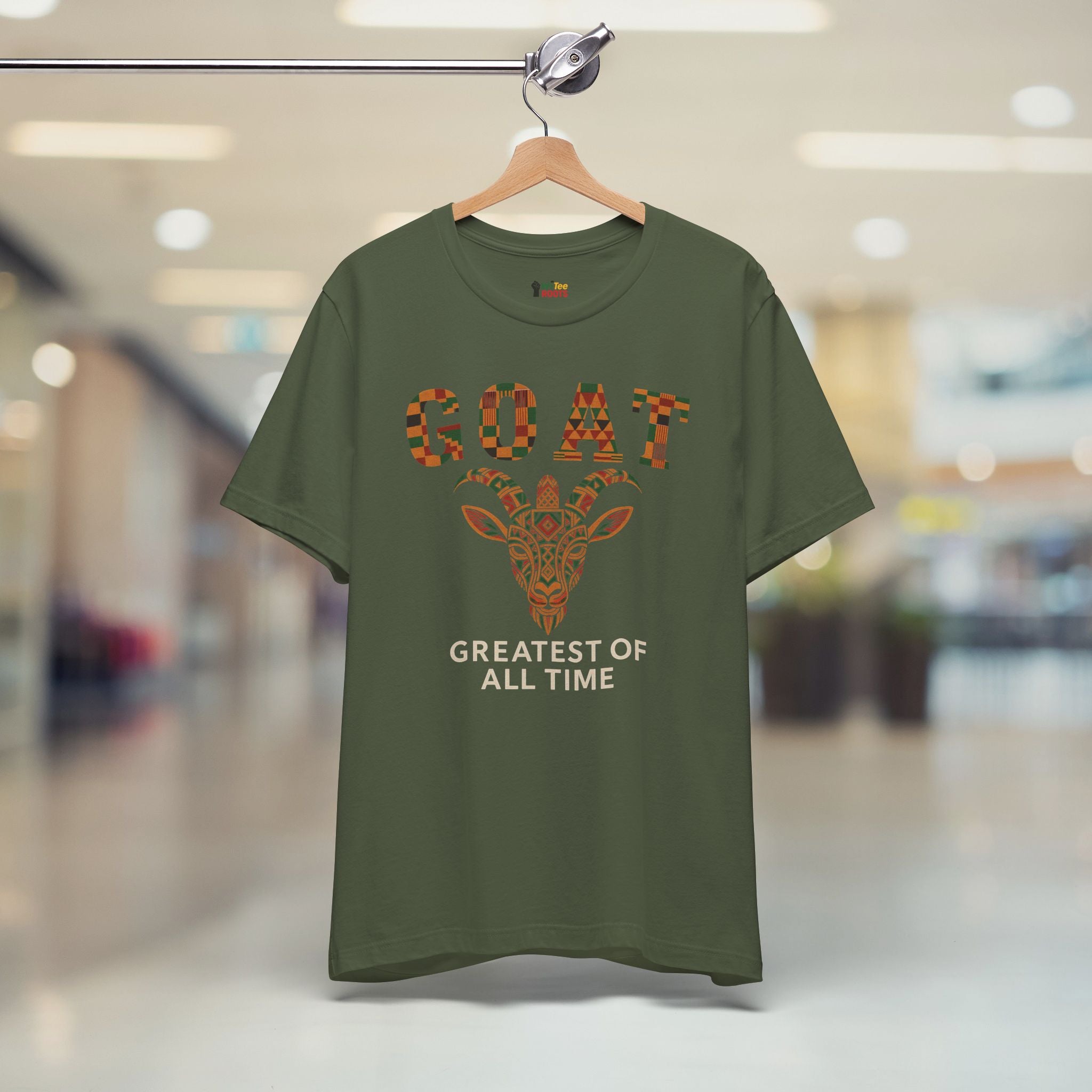 Green t-shirt with a giraffe graphic and text on a hanger in a store setting