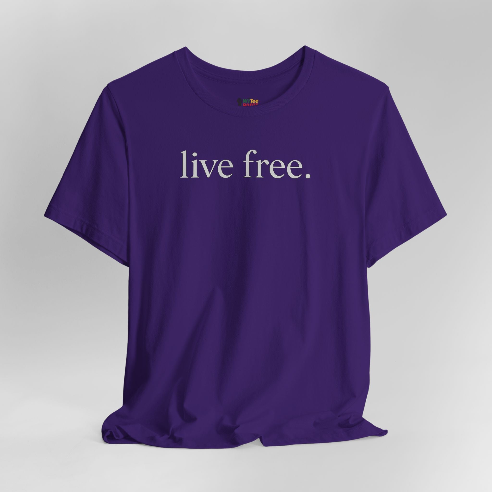 Purple t-shirt with 'live free' text on a grey background.