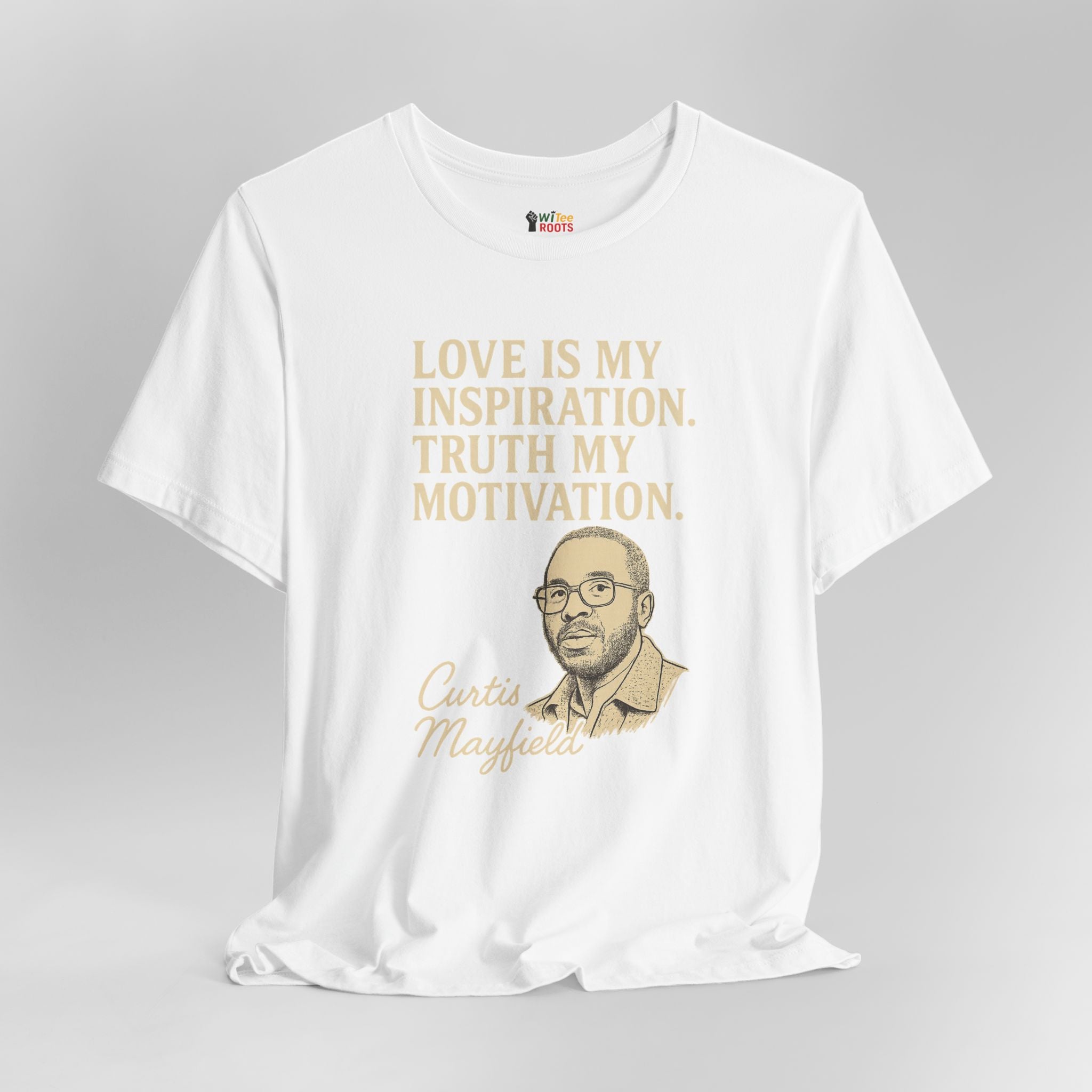 White t-shirt with gold text and a portrait on a gray background