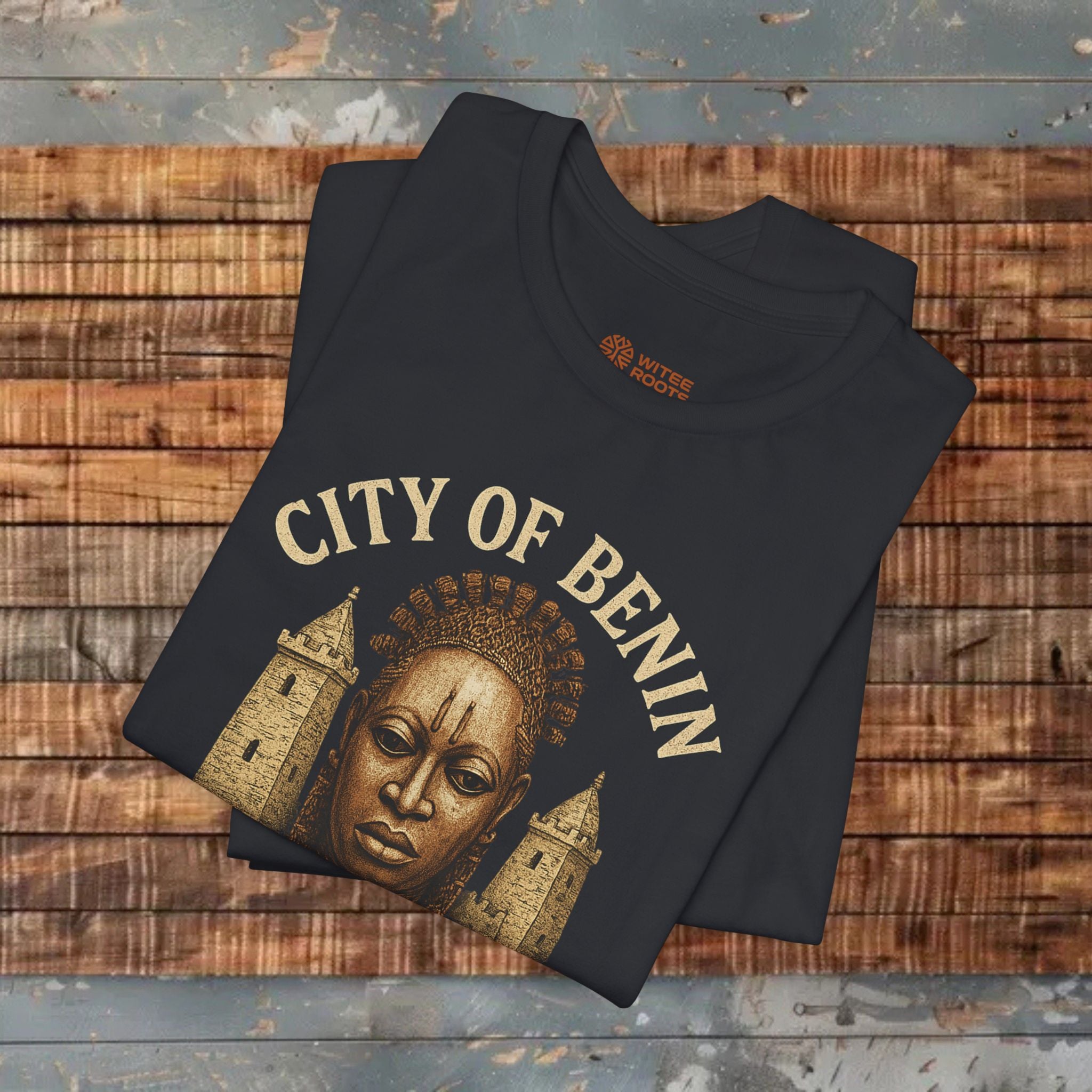 Black t-shirt with 'City of Benin' design on a wooden surface