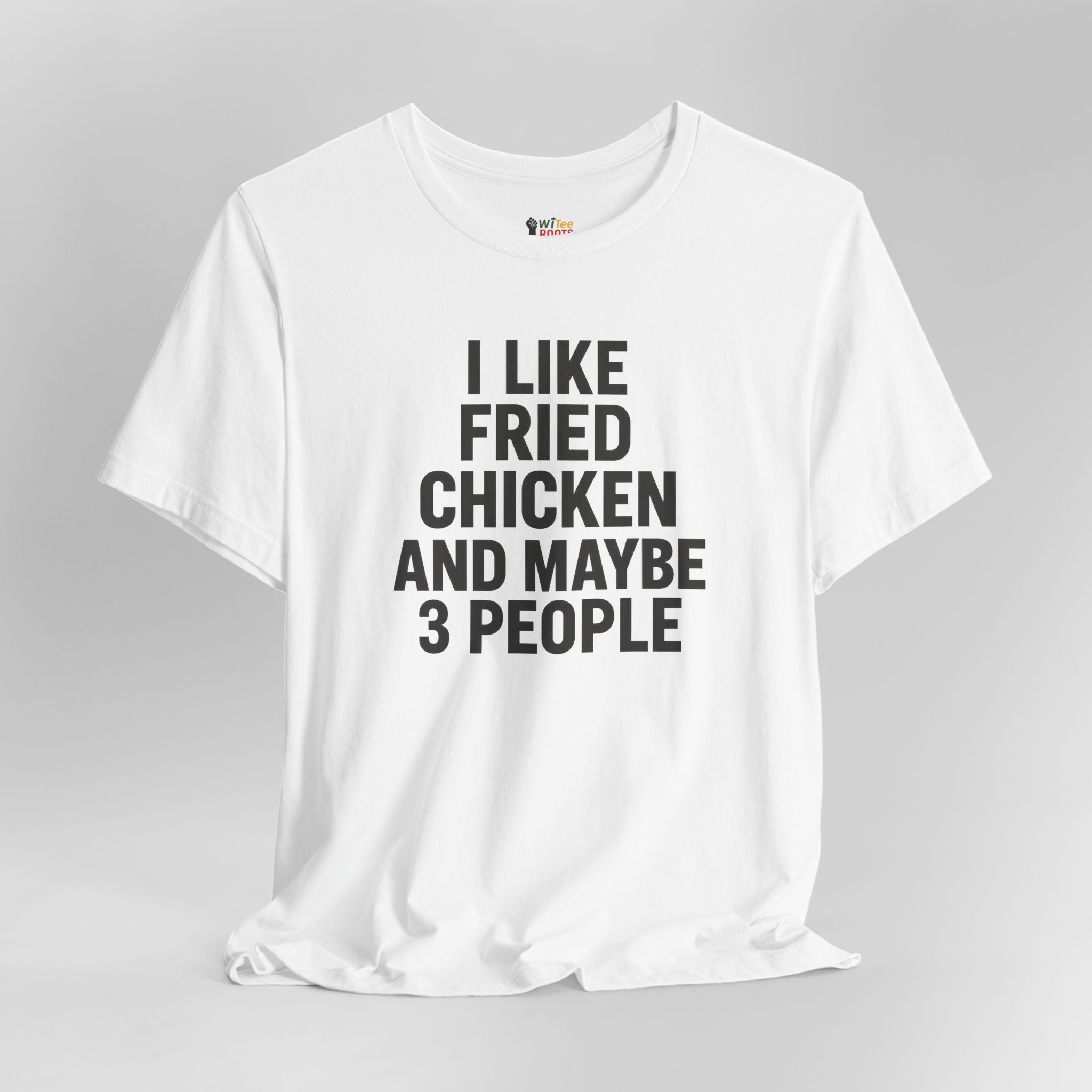 White t-shirt with black text 'I LIKE FRIED CHICKEN AND MAYBE 3 PEOPLE' on a gray background