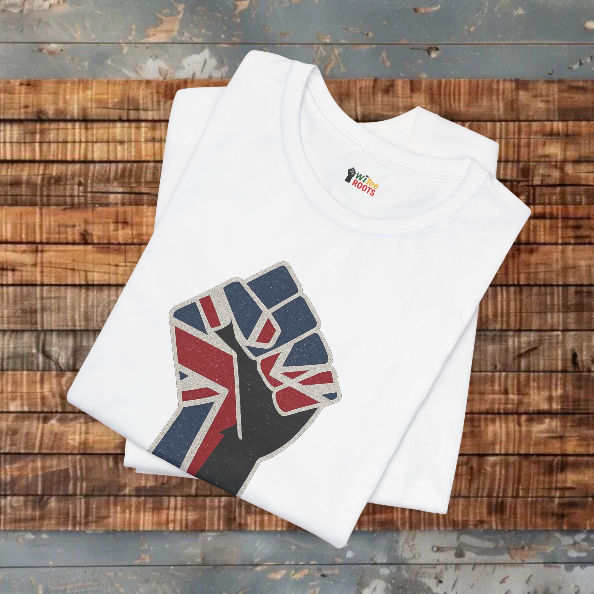 White t-shirt with a fist holding the Union Jack design on a wooden surface