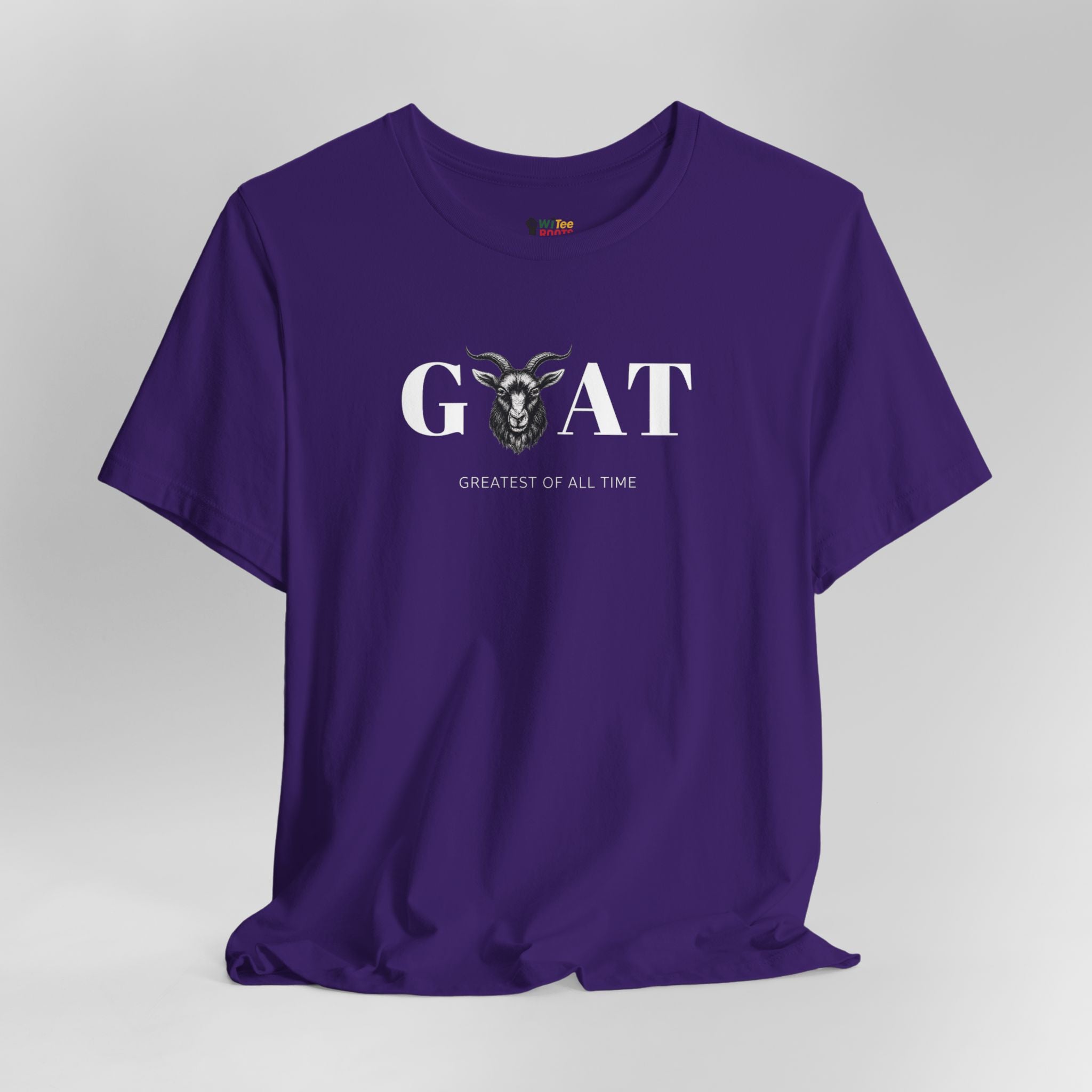 Purple t-shirt with 'Greatest of All Time' text and goat graphic on a gray background