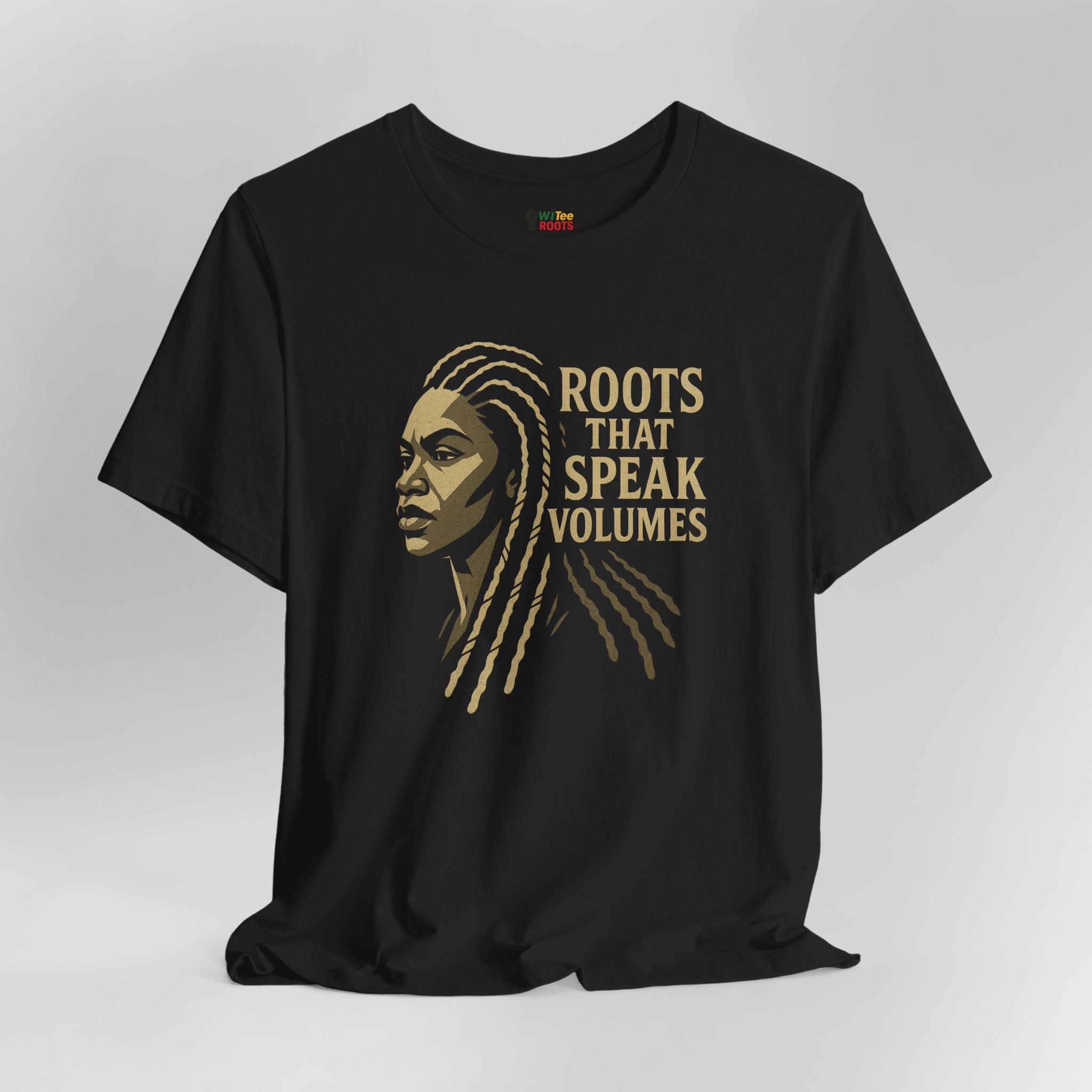 Black t-shirt with gold graphic and text 'ROOTS THAT SPEAK VOLUMES' on a gray background