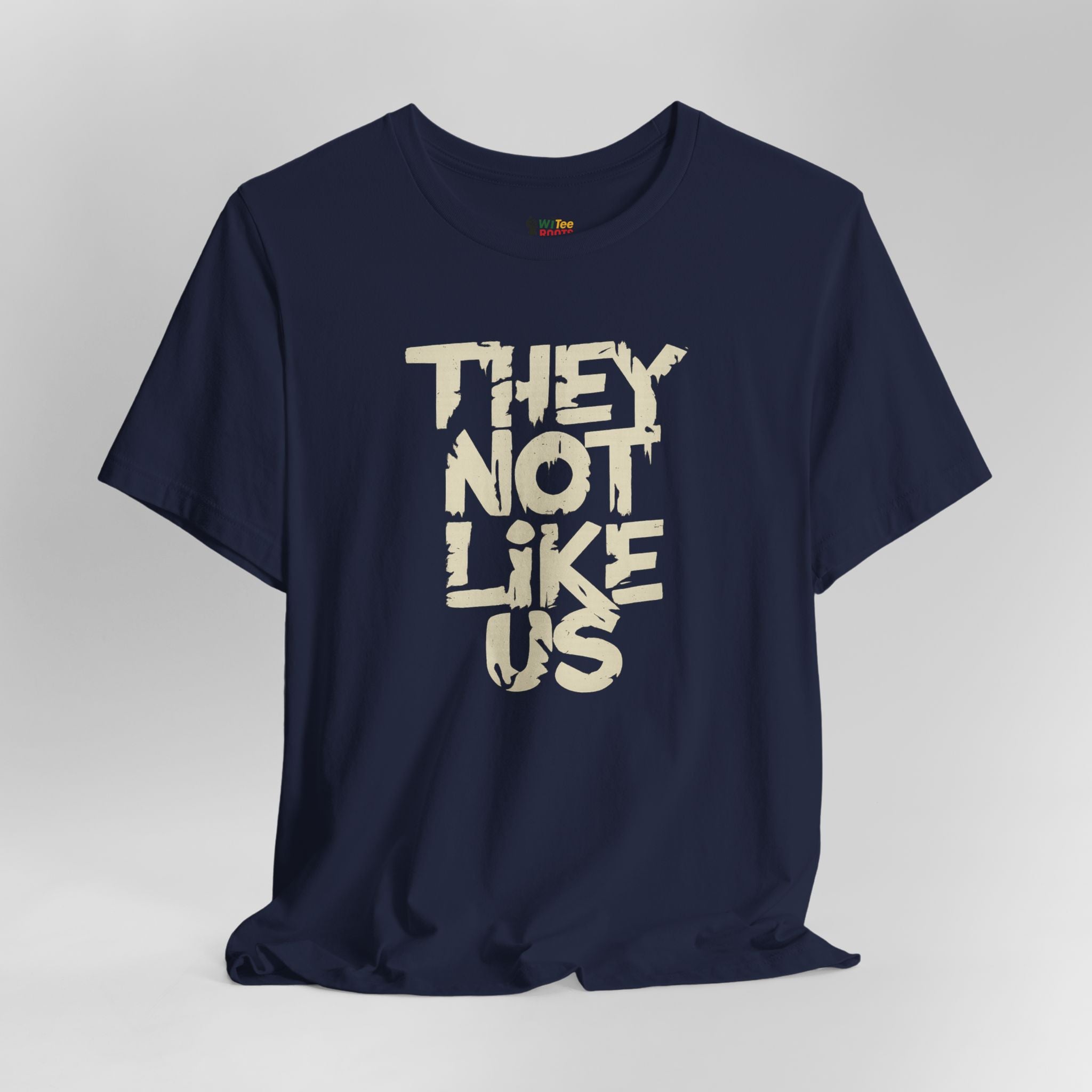 Navy blue t-shirt with beige text 'THEY NOT LIKE US' on a light gray background