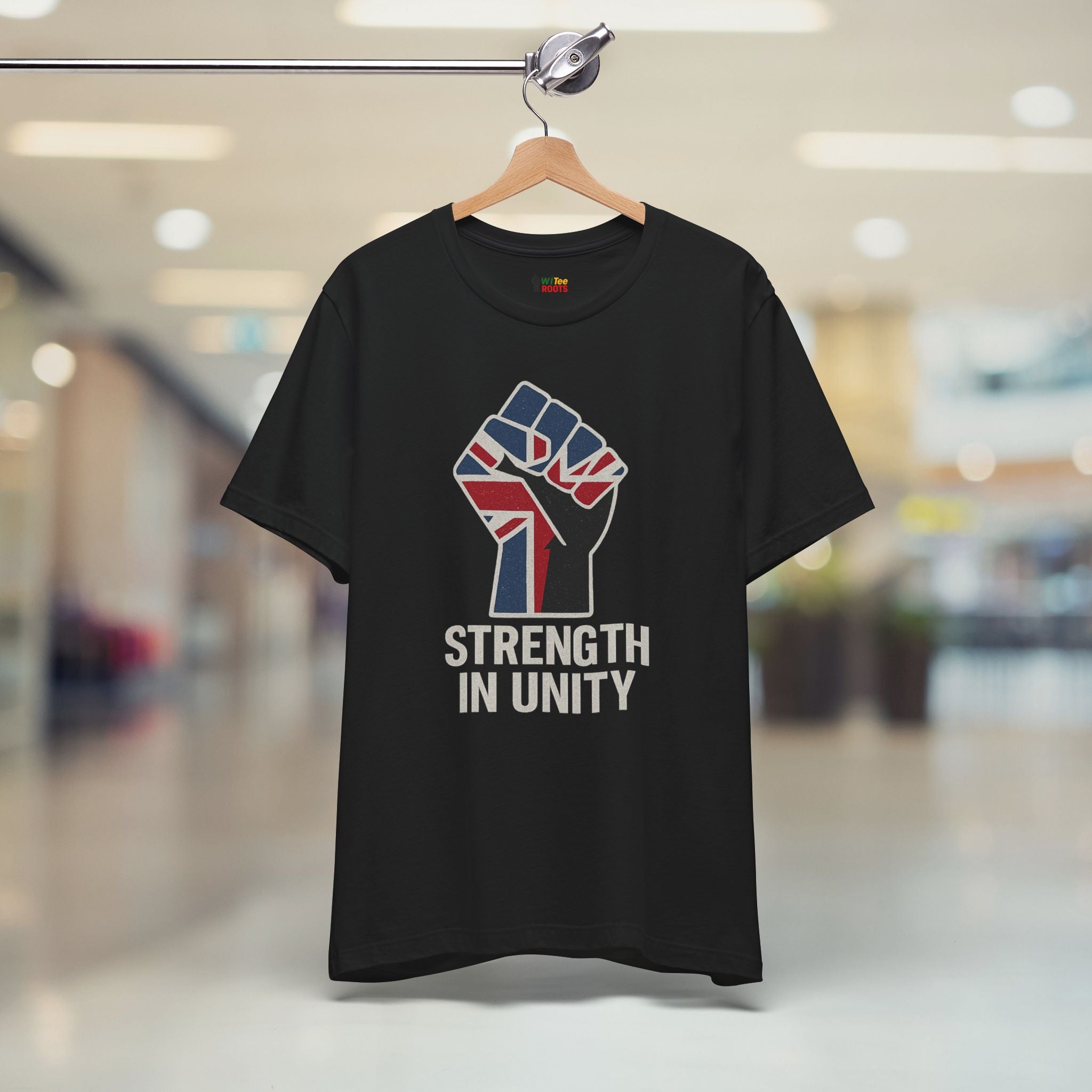 Black t-shirt with a fist holding the Union Jack and 'Strength in Unity' text on a hanger.