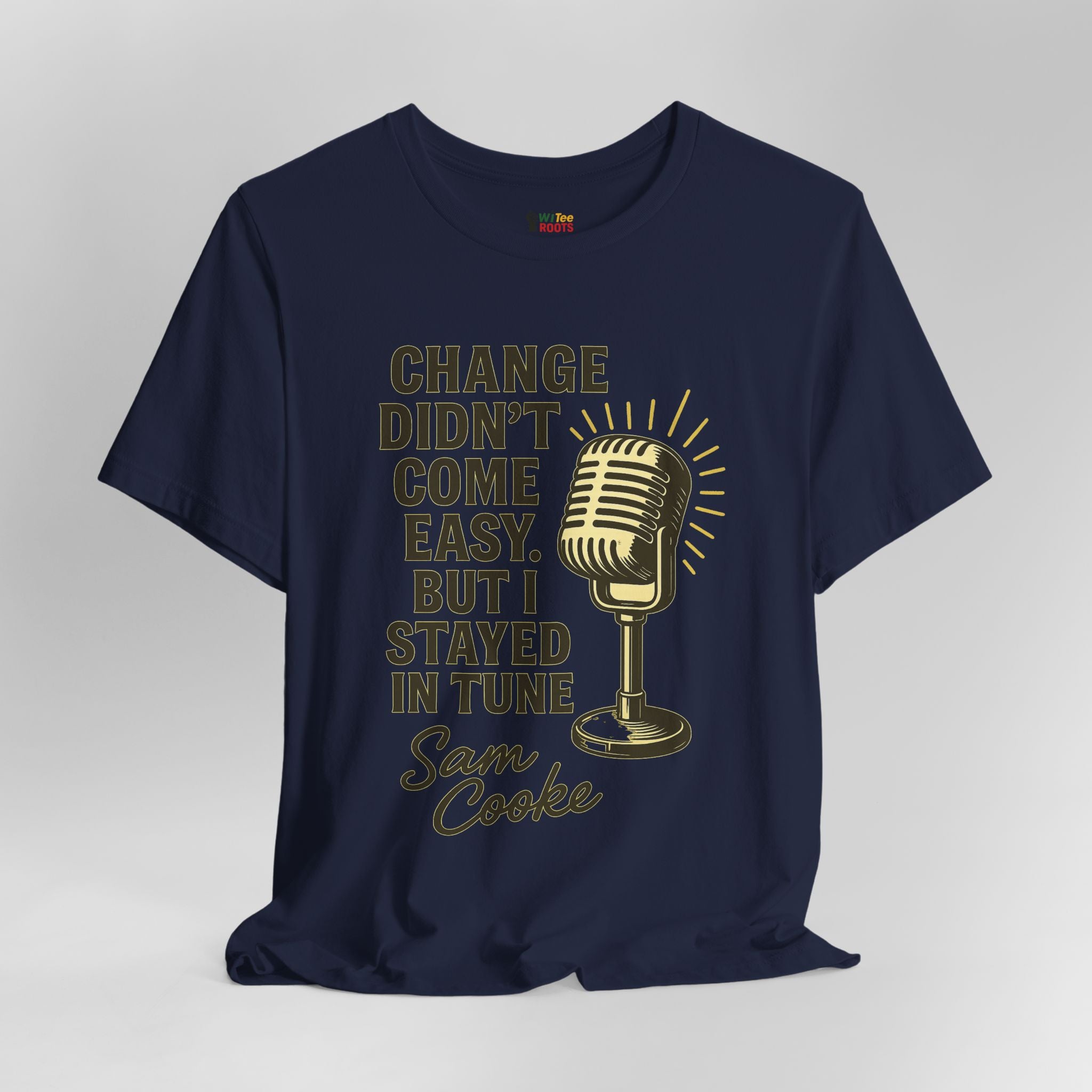 Navy blue t-shirt with gold microphone graphic and text on a gray background