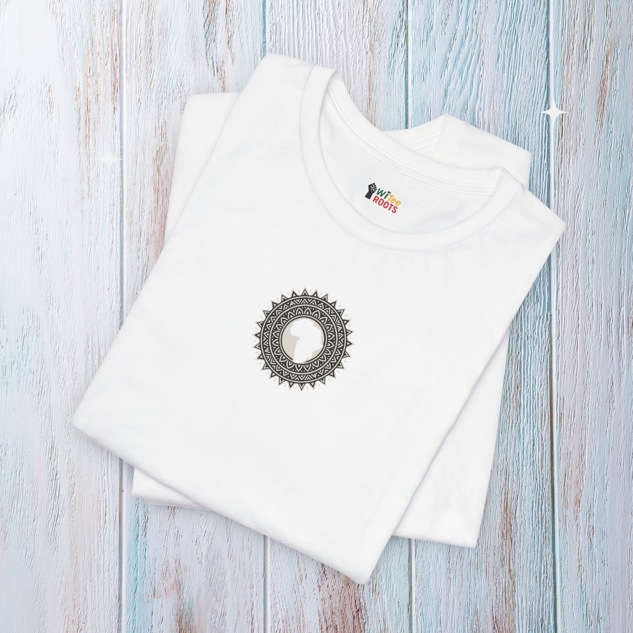 White t-shirt with a circular design and brand logo on a light wooden surface