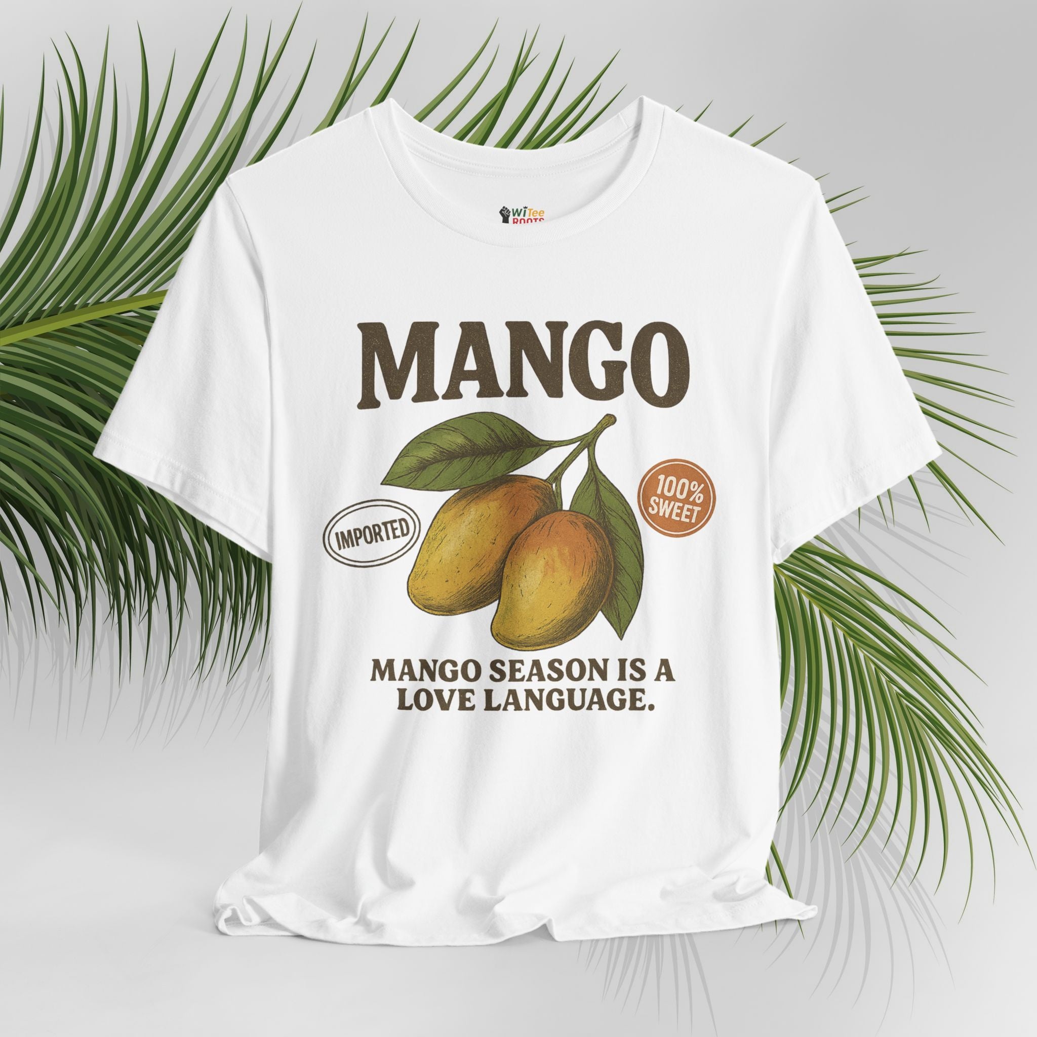 White t-shirt with mango graphic and text on a light gray background with green leaves.