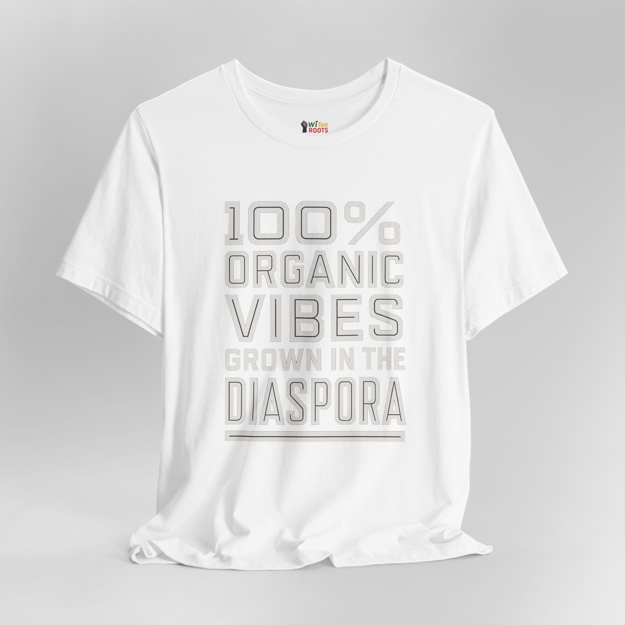 White t-shirt with text '100% Organic Vibes Grown in the Diaspora' on a gray background