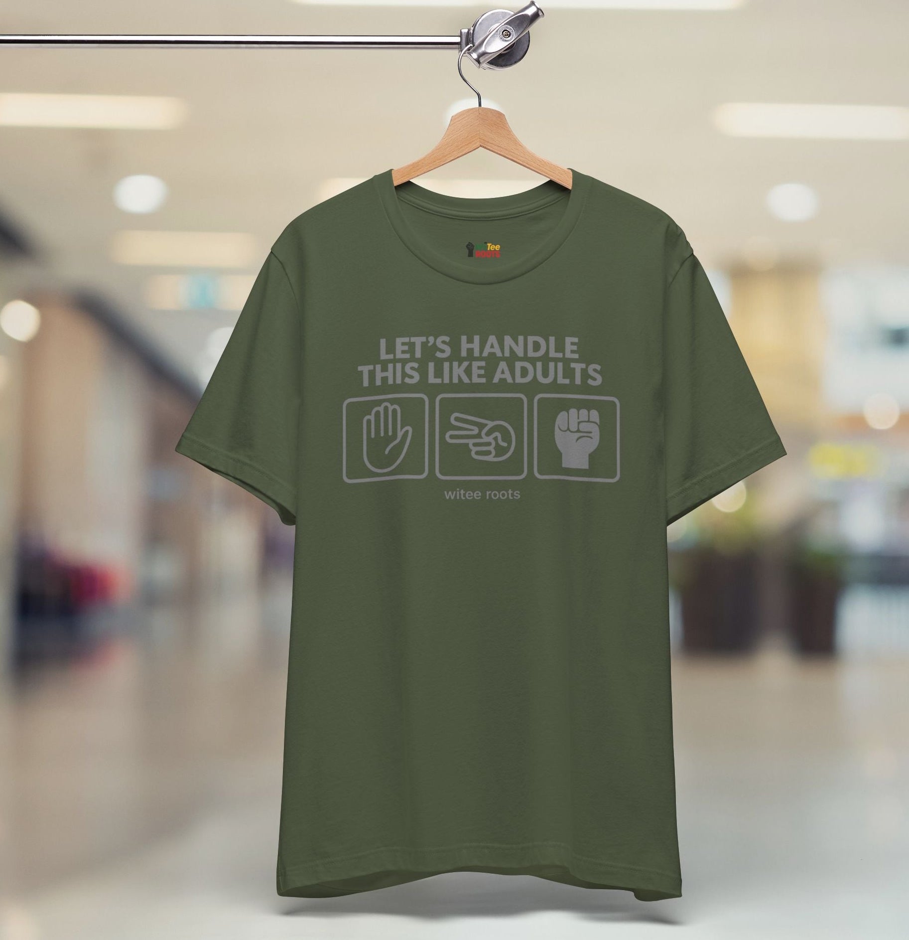 Green t-shirt with text and symbols on a hanger in a store setting