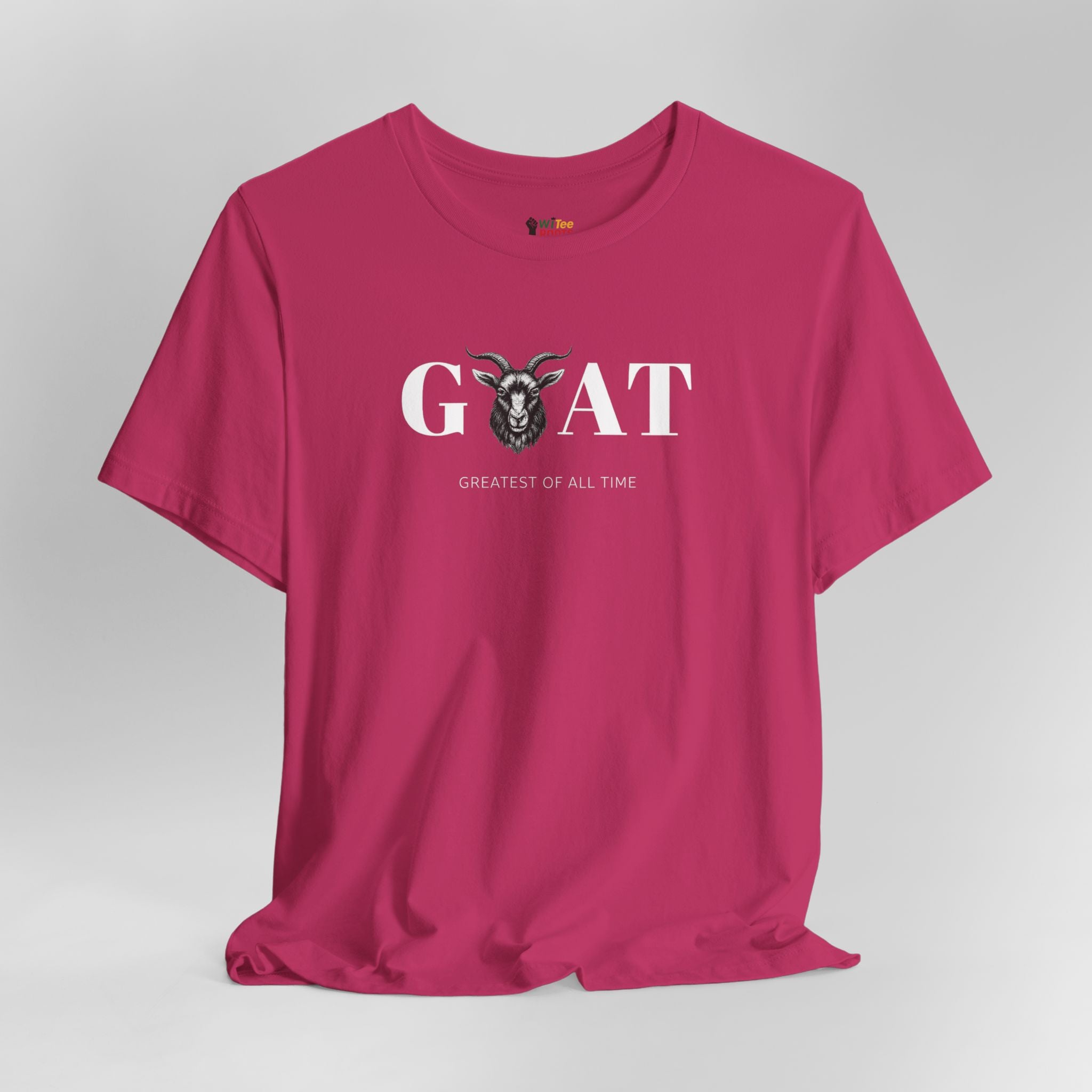Pink t-shirt with 'Greatest of All Time' text and goat graphic on a gray background