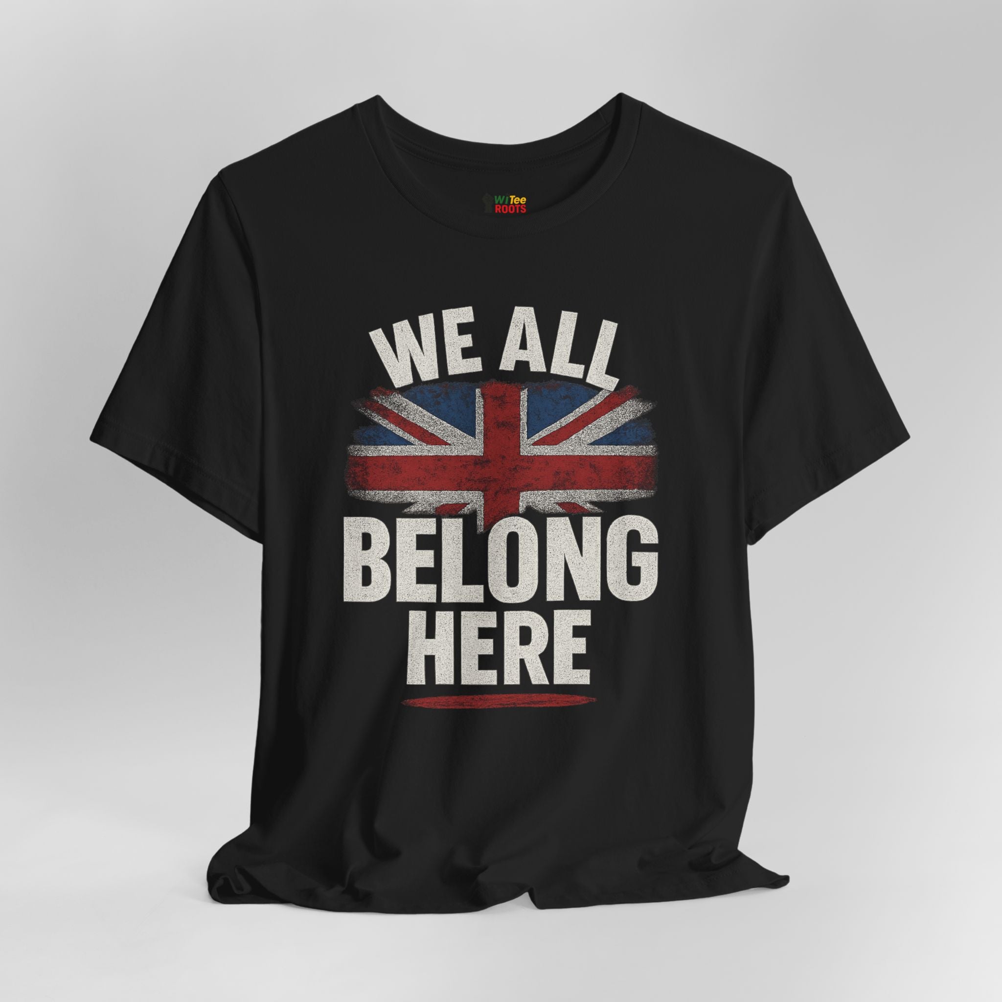 Black t-shirt with 'We All Belong Here' text and Union Jack design on a gray background