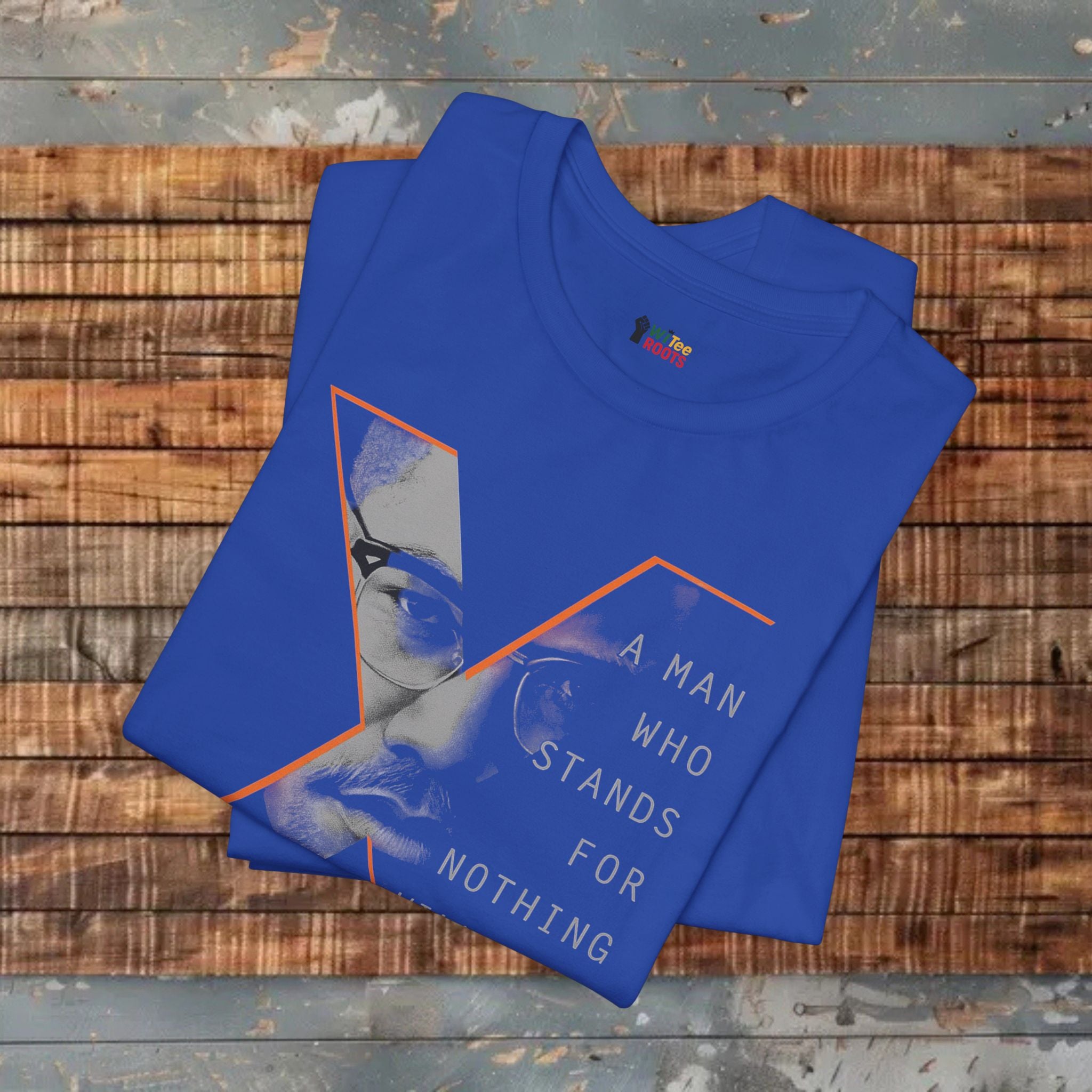 Blue t-shirt with graphic design and text on a wooden surface