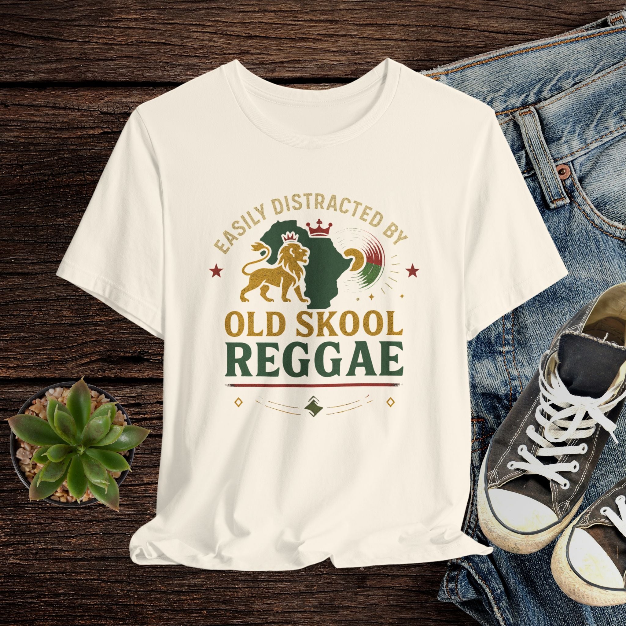 Beife t-shirt with 'Old Skool Reggae' design on a wooden surface with jeans and sneakers.