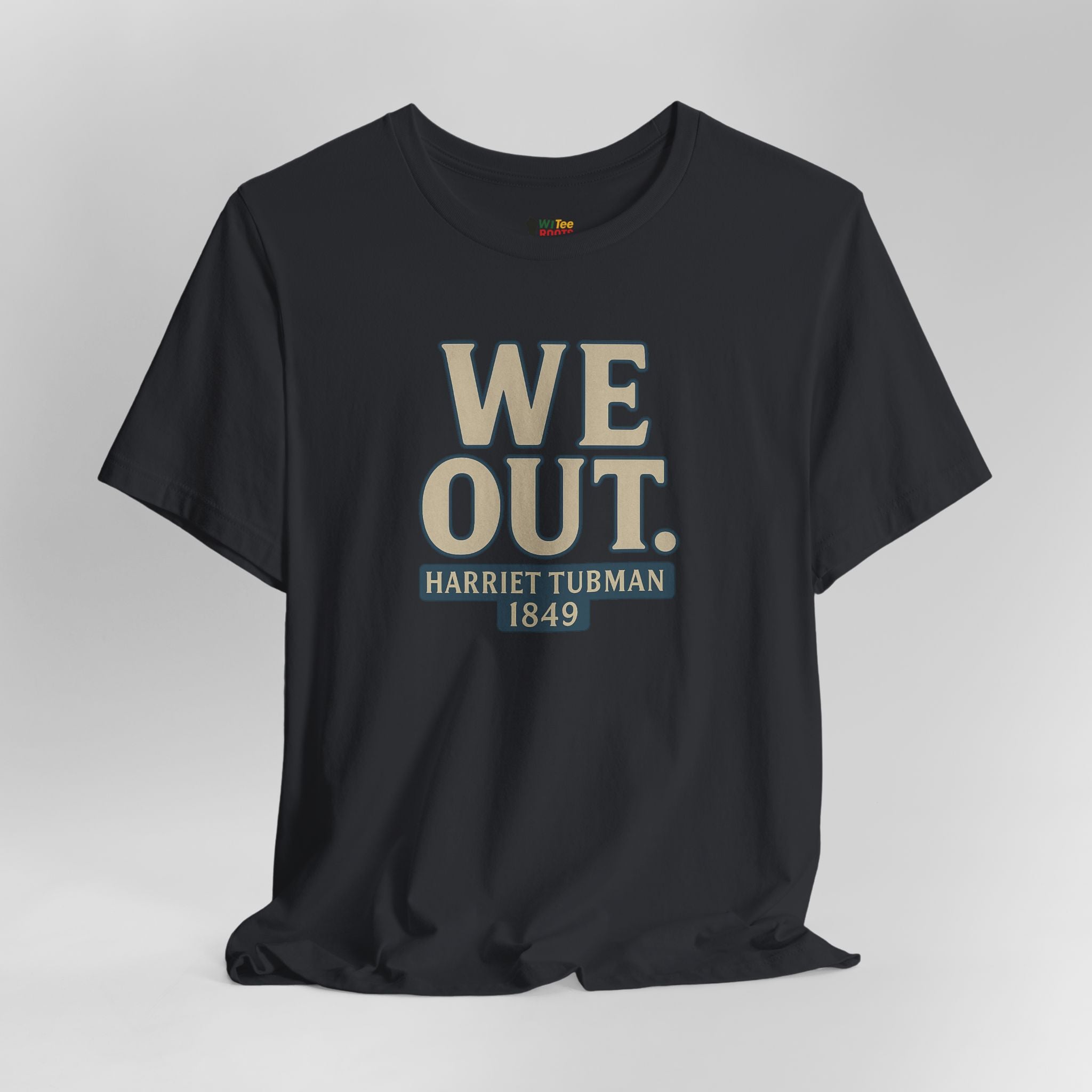 Black t-shirt with 'WE OUT. Harriet Tubman 1849' text on a gray background