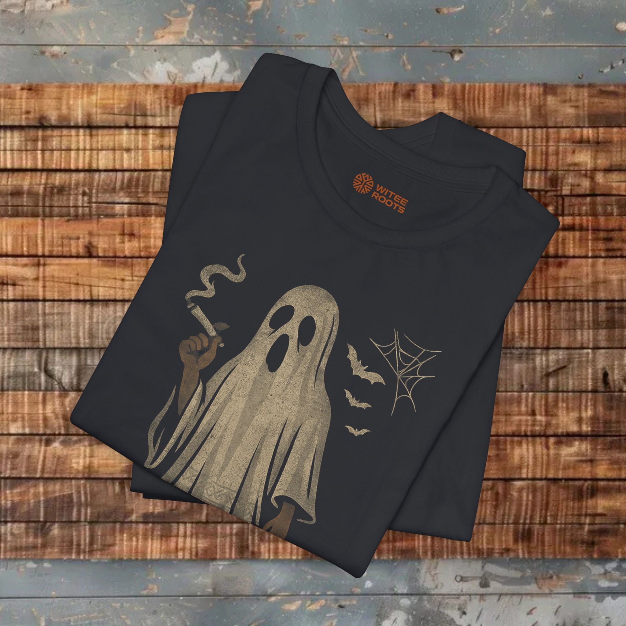 Black t-shirt with ghost design on a wooden surface