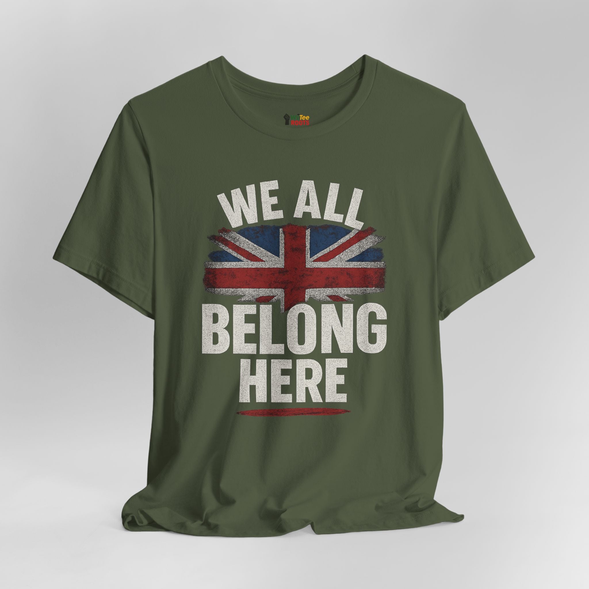 Green t-shirt with a Union Jack design and text 'WE ALL BELONG HERE' on a gray background