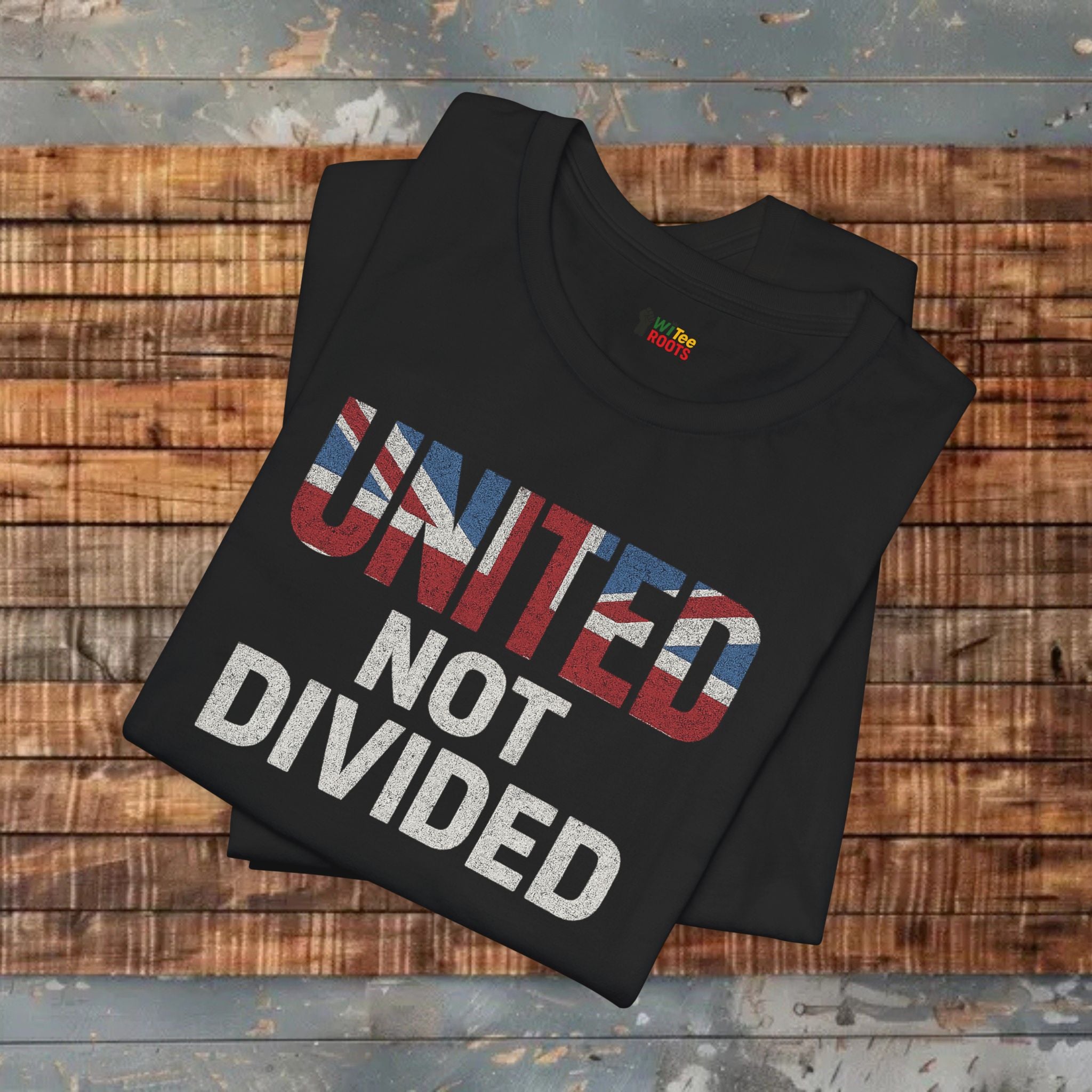 Black t-shirt with 'UNITED NOT DIVIDED' text on a wooden surface