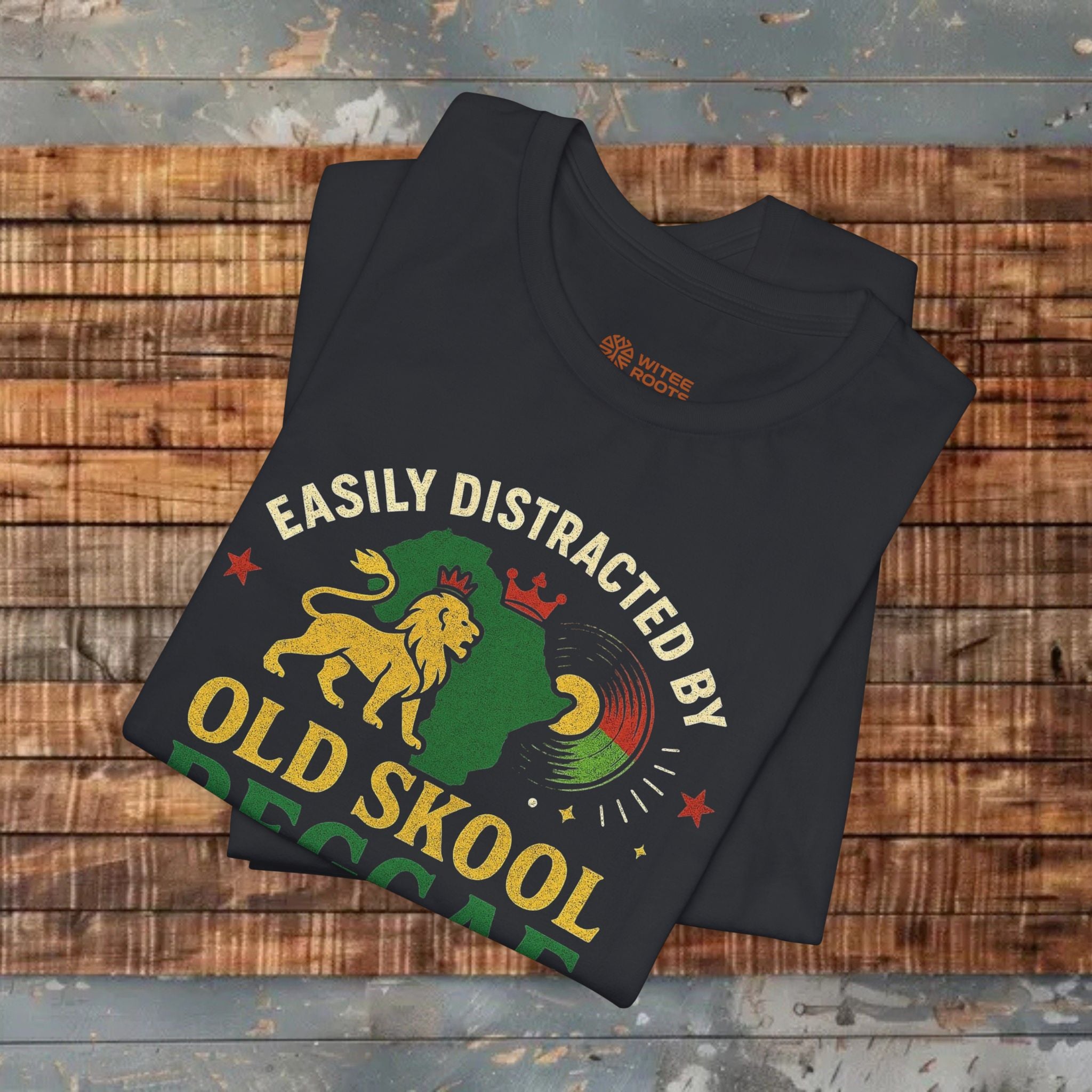 Black t-shirt with graphic design and text on a wooden surface