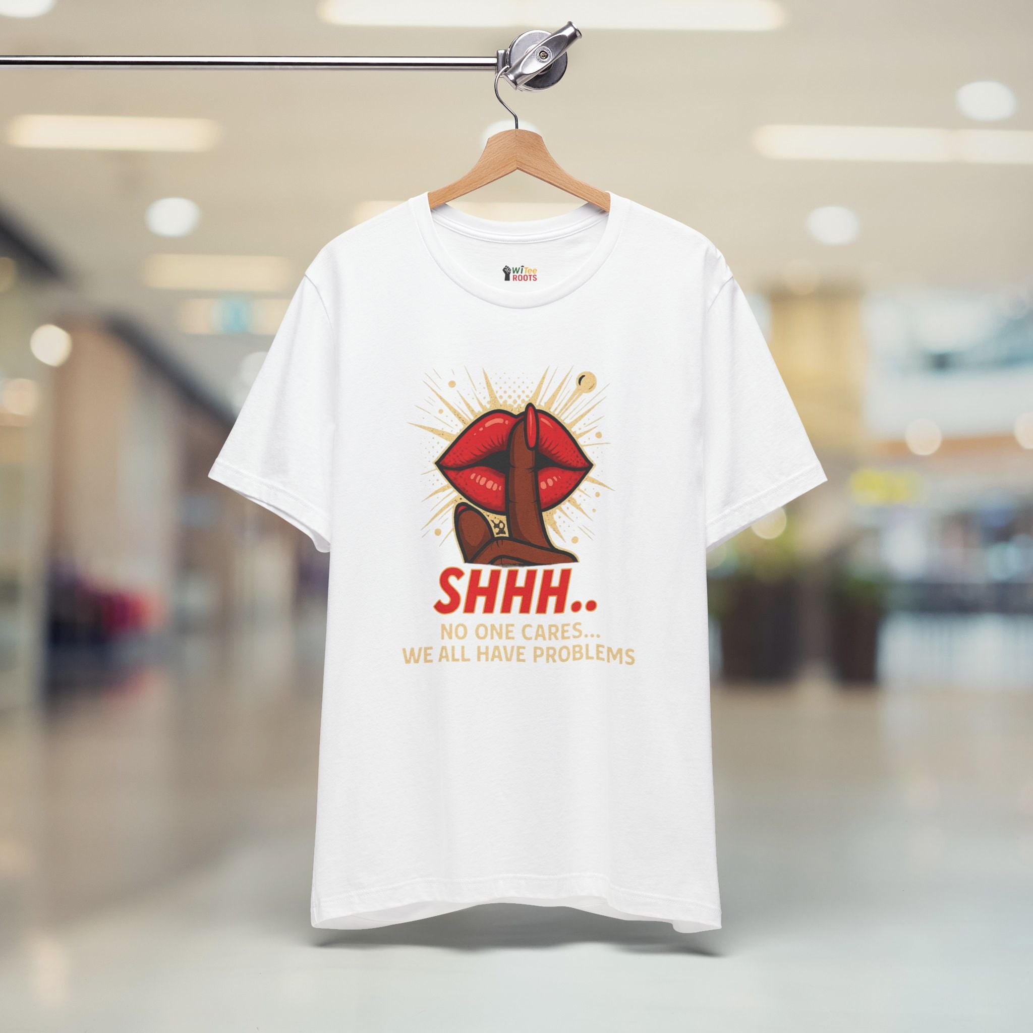 White t-shirt with a graphic design and text on a hanger in a store setting