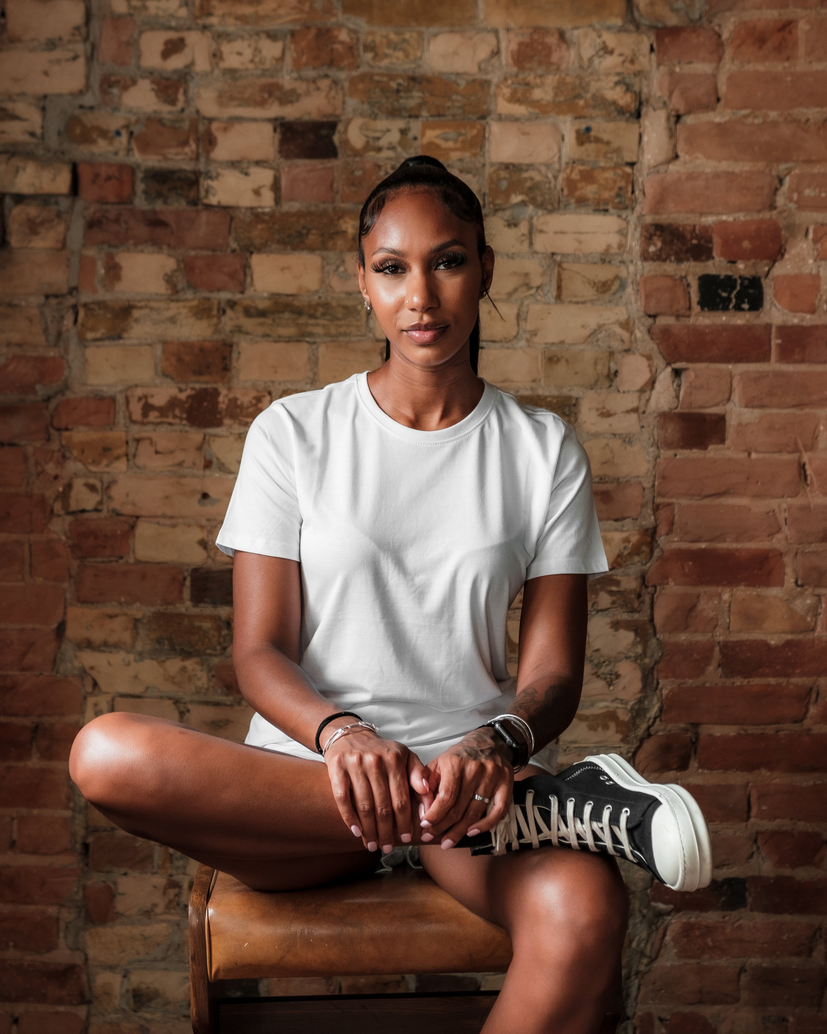 Woman sitting wearing white Tshirt