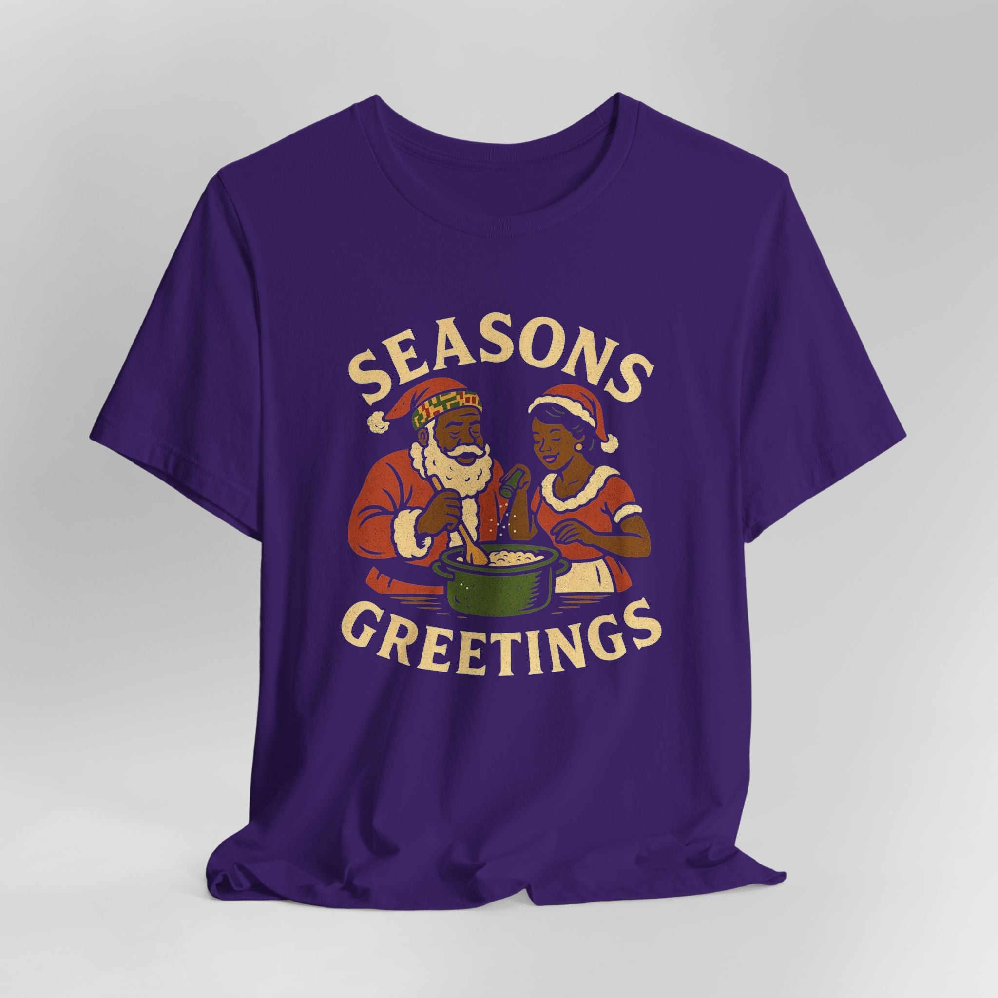 Purple t-shirt with 'Seasons Greetings' graphic on a gray background