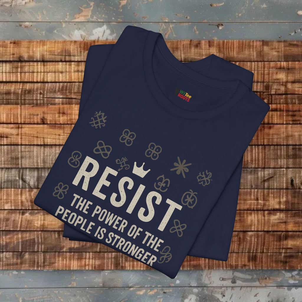 Folded navy blue t-shirt with 'RESIST' text on a wooden surface