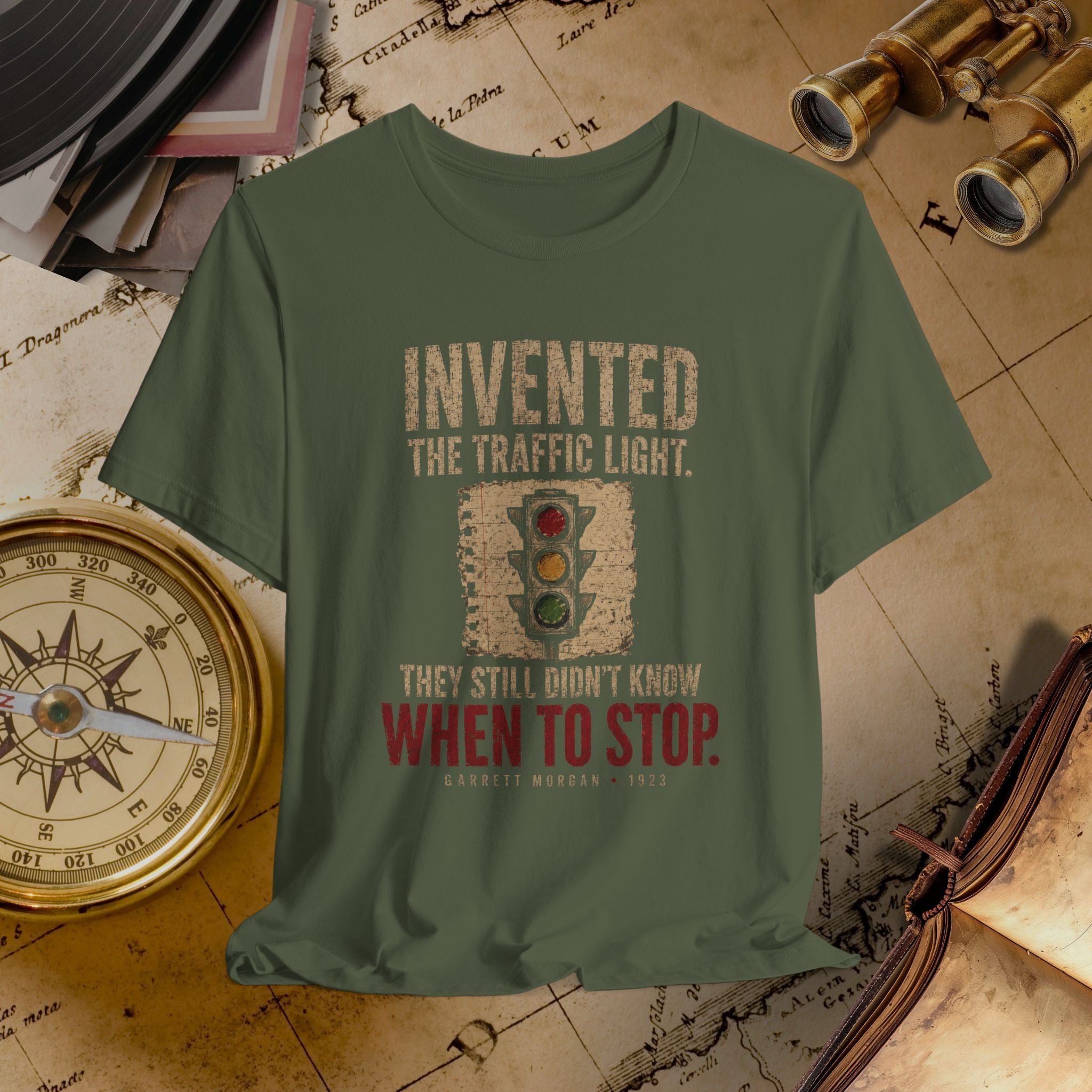 Green t-shirt with traffic light graphic and text on a vintage map background