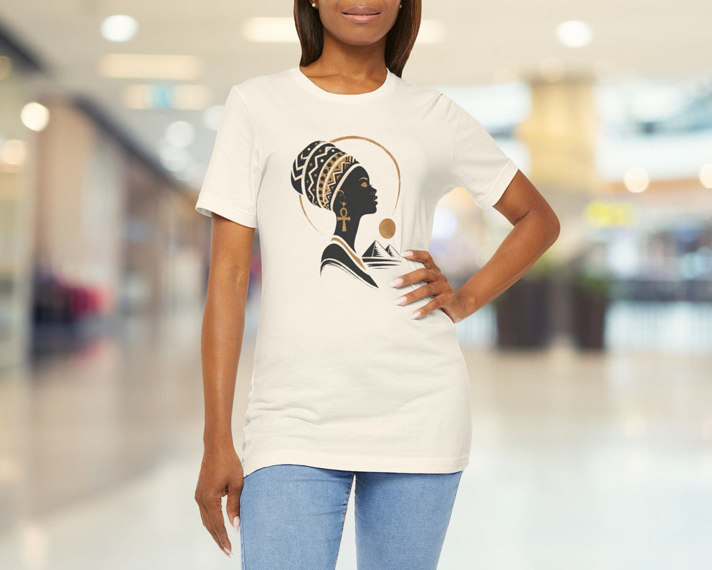 Woman wearing a white t-shirt with a graphic design in a blurred indoor setting
