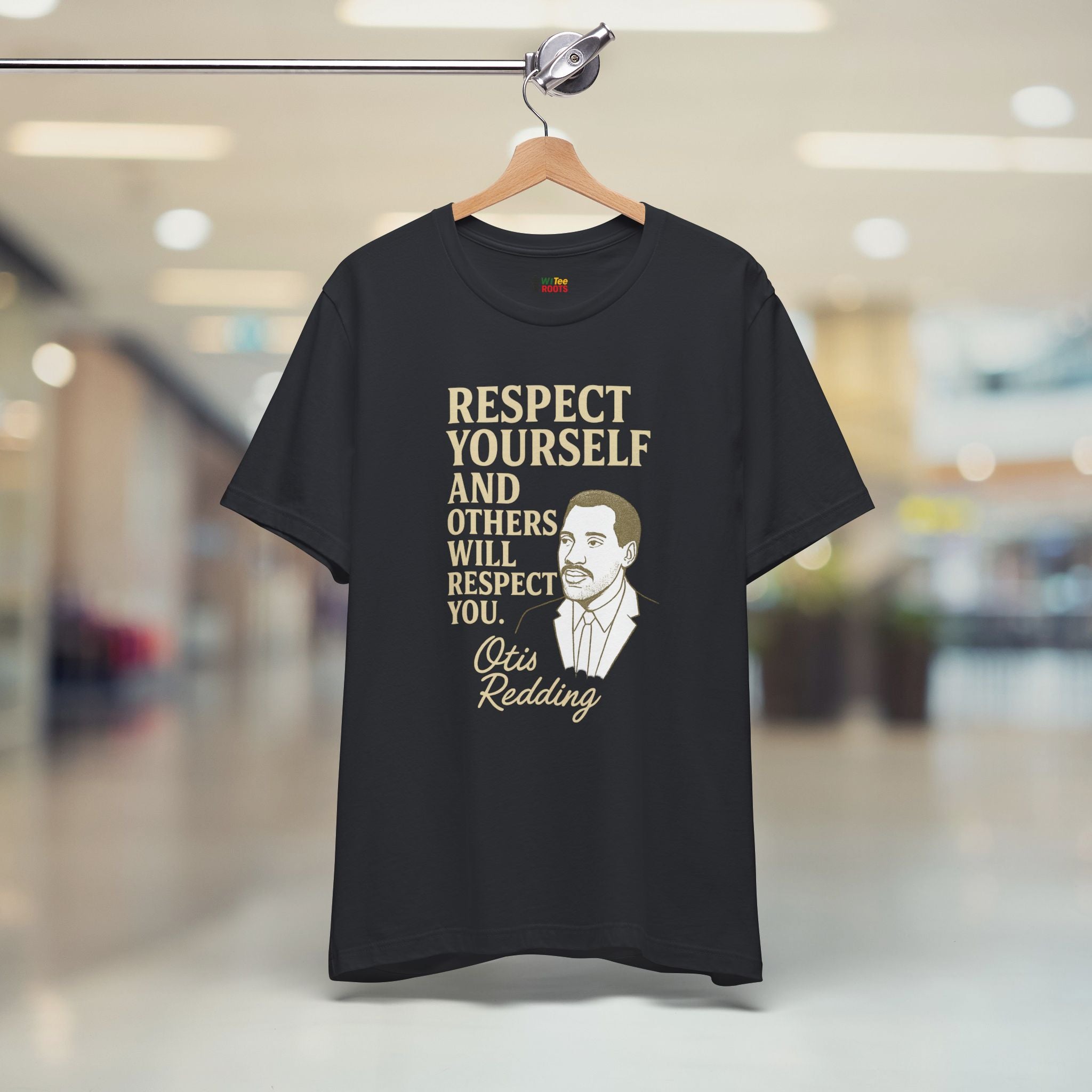 Black t-shirt with a quote and a man's face on a hanger in a store.