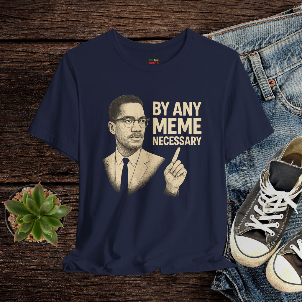 Navy blue t-shirt with a graphic of a man and text 'By Any Meme Necessary' on a wooden surface with jeans and sneakers.