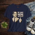 Navy blue t-shirt with a graphic of a man and text 'By Any Meme Necessary' on a wooden surface with jeans and sneakers.