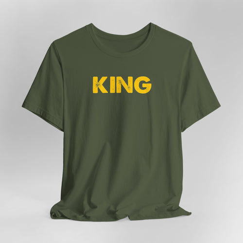 Green t-shirt with 'KING' printed in yellow on a white background