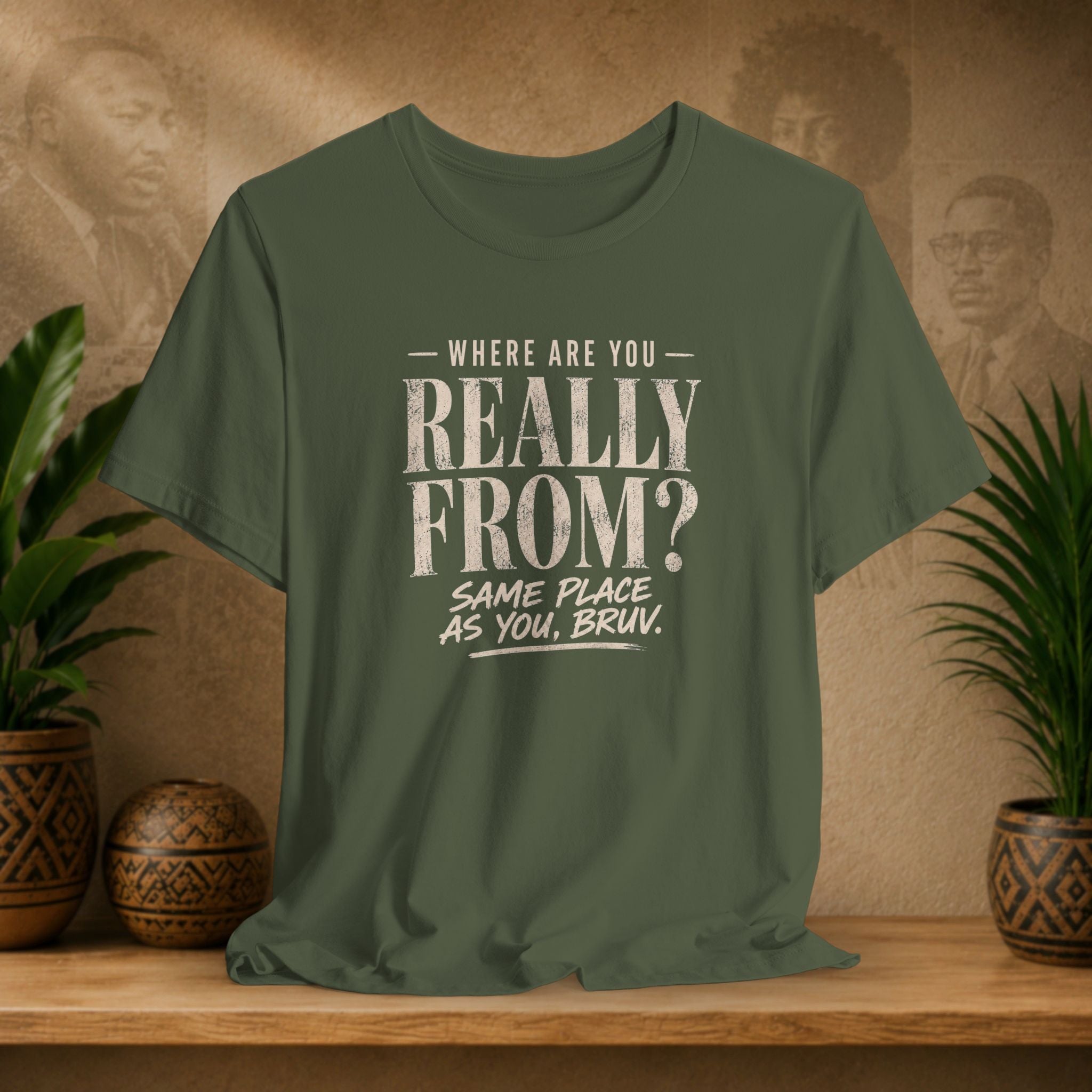 Green t-shirt with humorous text design on a wooden surface with plants and a textured wall background.