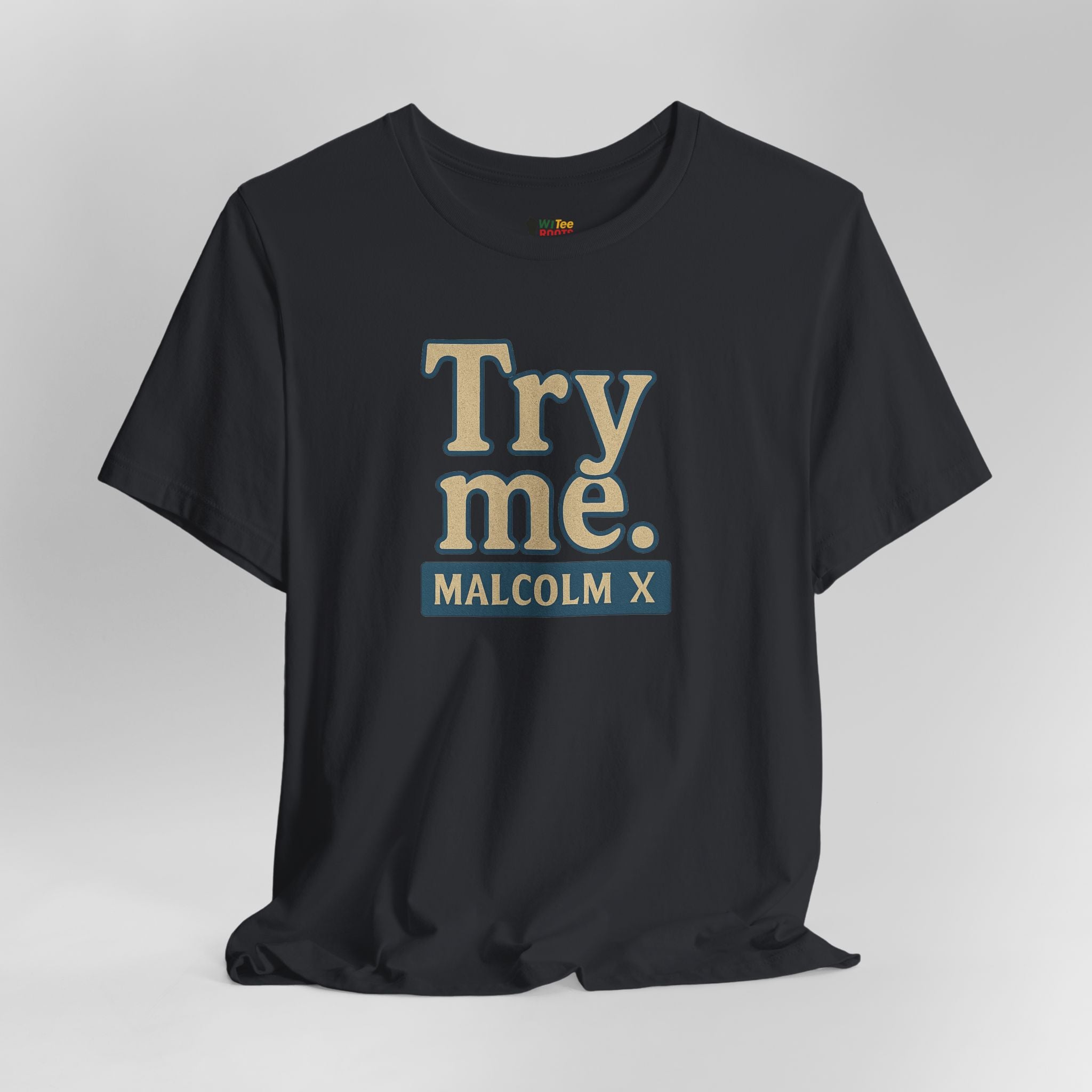 Black t-shirt with 'Try me. MALCOLM X' text on a gray background
