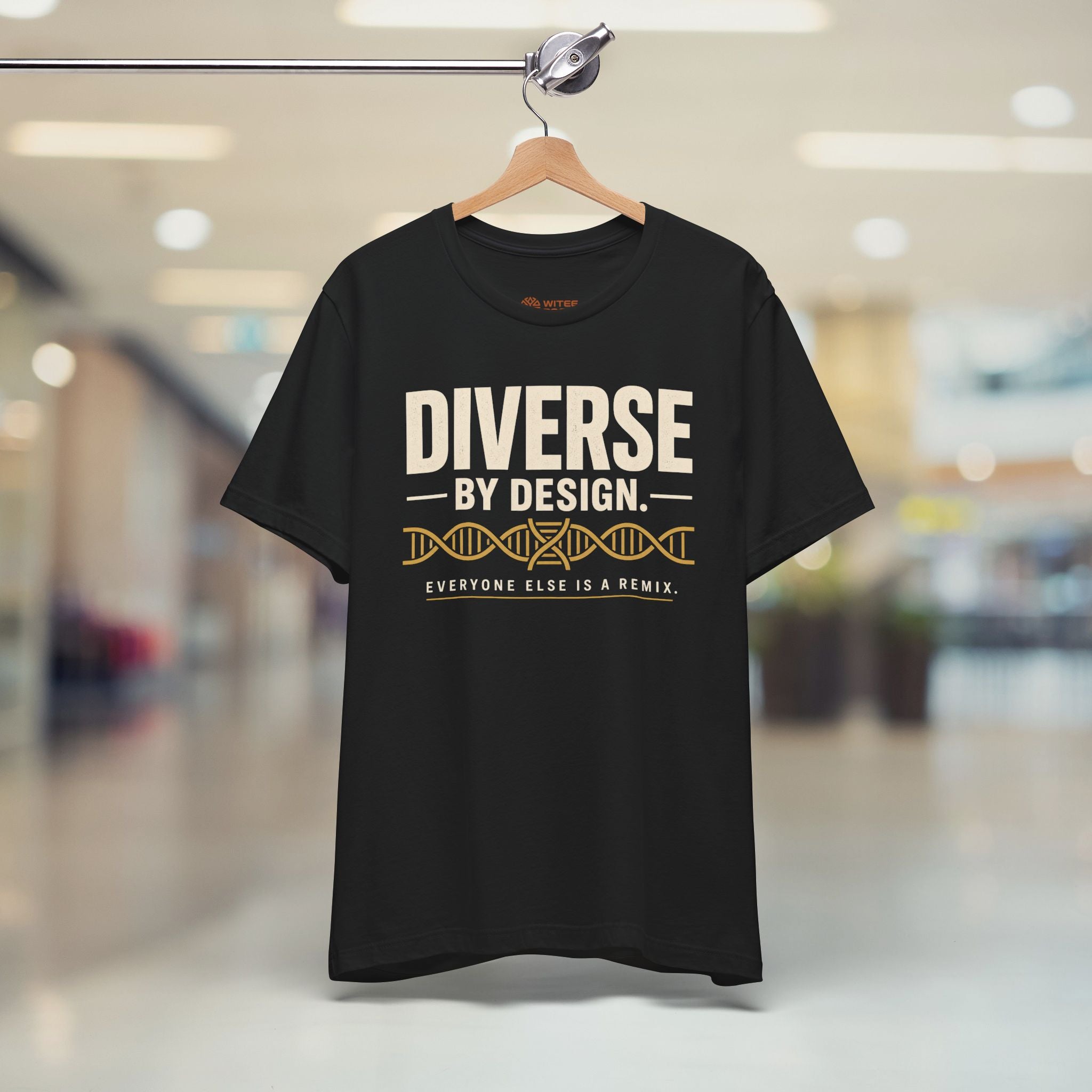 Black t-shirt with 'Diverse by Design' text on a hanger in a store.