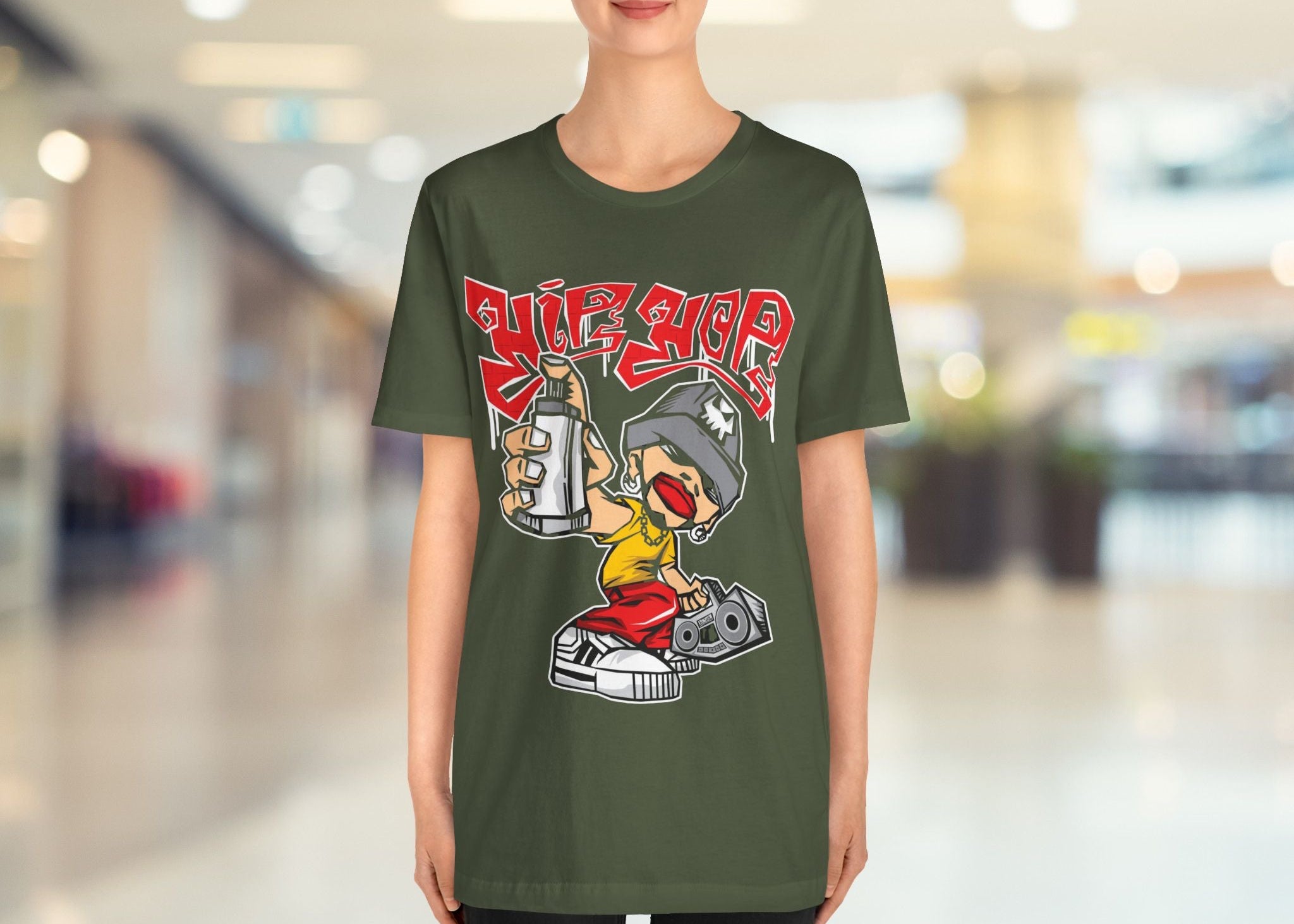 Person wearing a green t-shirt with a graphic design in an indoor setting