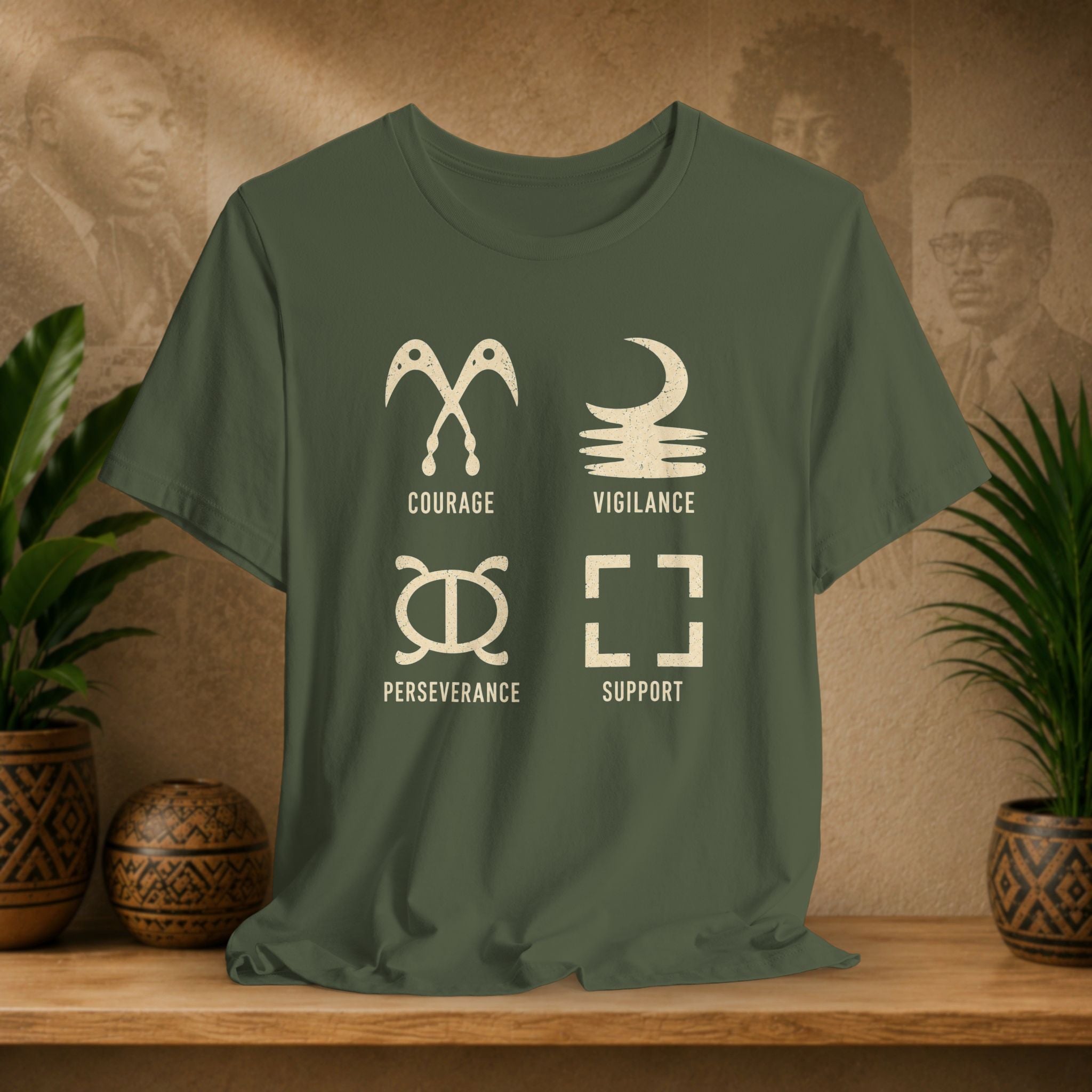 Green t-shirt with white symbols and text on a wooden surface with plants and a textured wall background